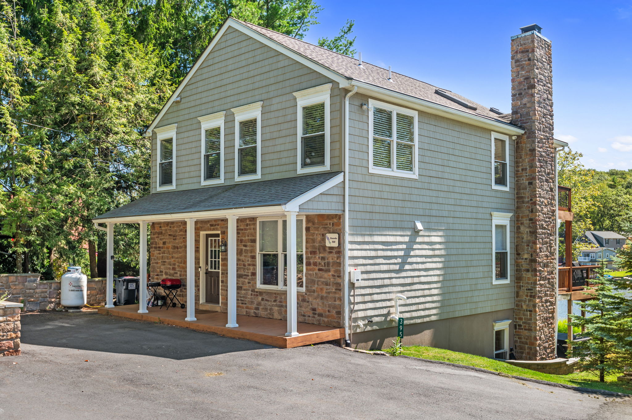 Street-side view of the charming lake house with stone and siding exterior