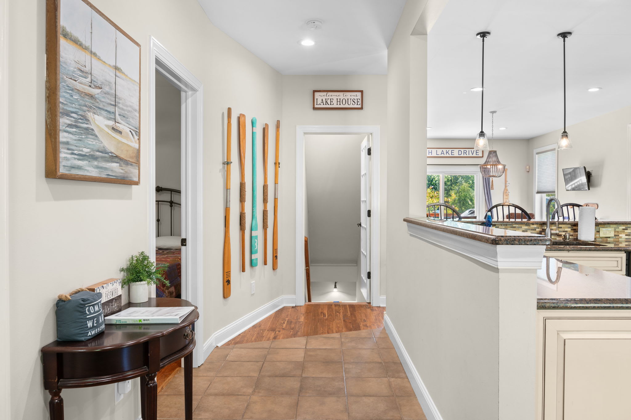 A warm lake house welcome with cozy decor and an open flow to the kitchen