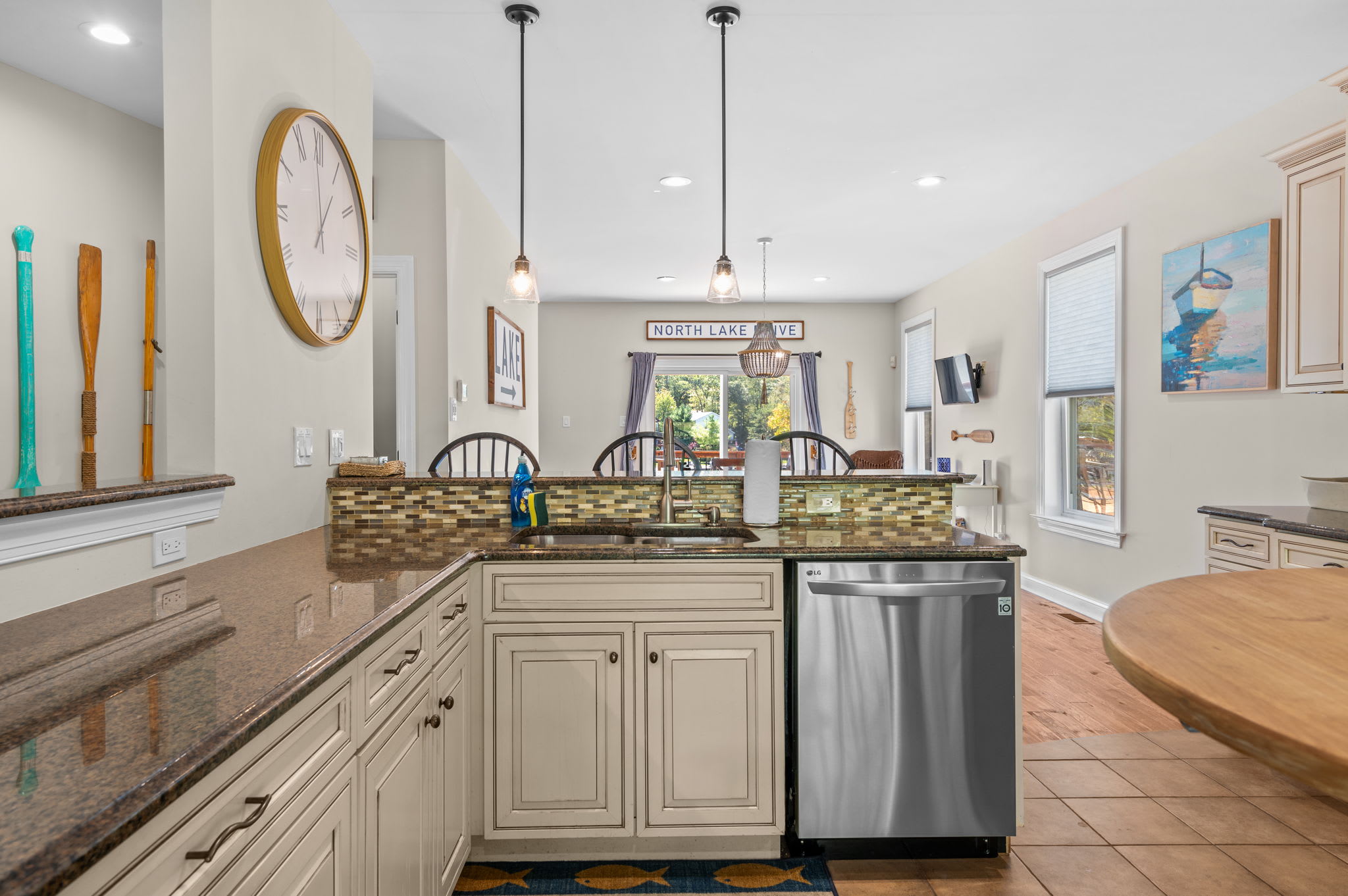 Bright kitchen with pendant lighting, dishwasher, and views to the dining area