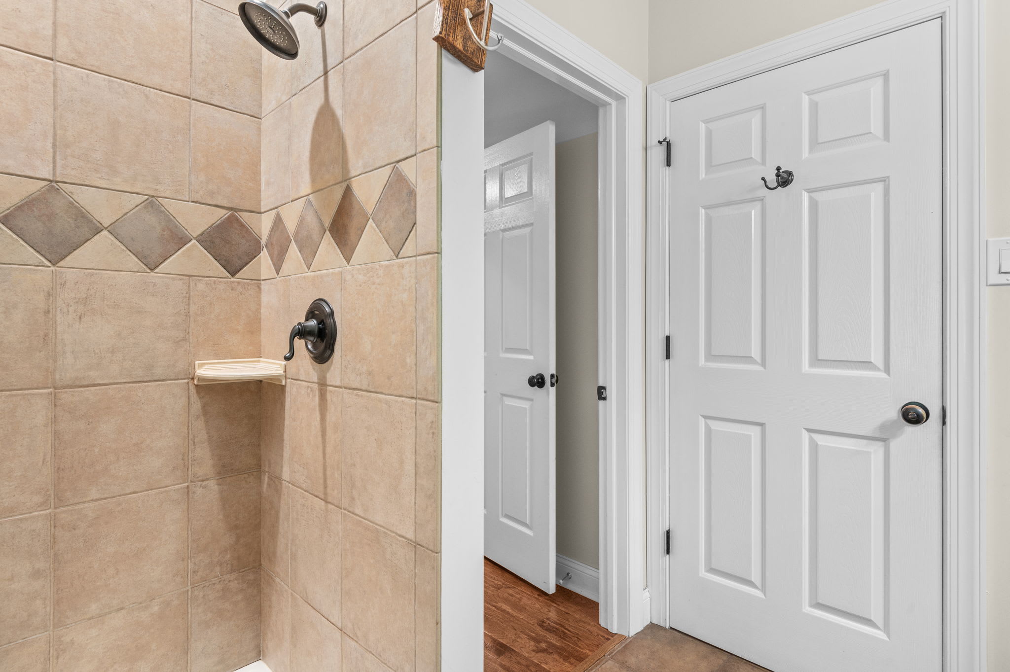Step into the tiled walk-in shower after a long day on the lake