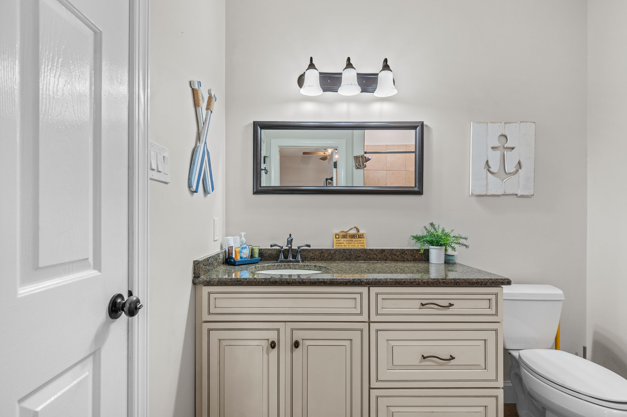 Freshen up in the nautical-themed bathroom with a granite vanity