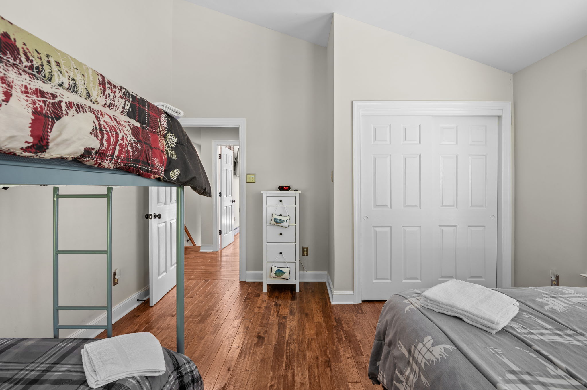 Cozy sitting area with a plush sectional, hardwood floors, and natural light