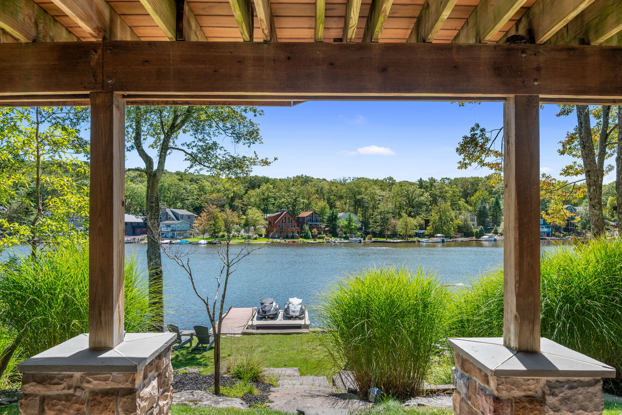 Take in the lake from the covered patio with dock and waterfront views
