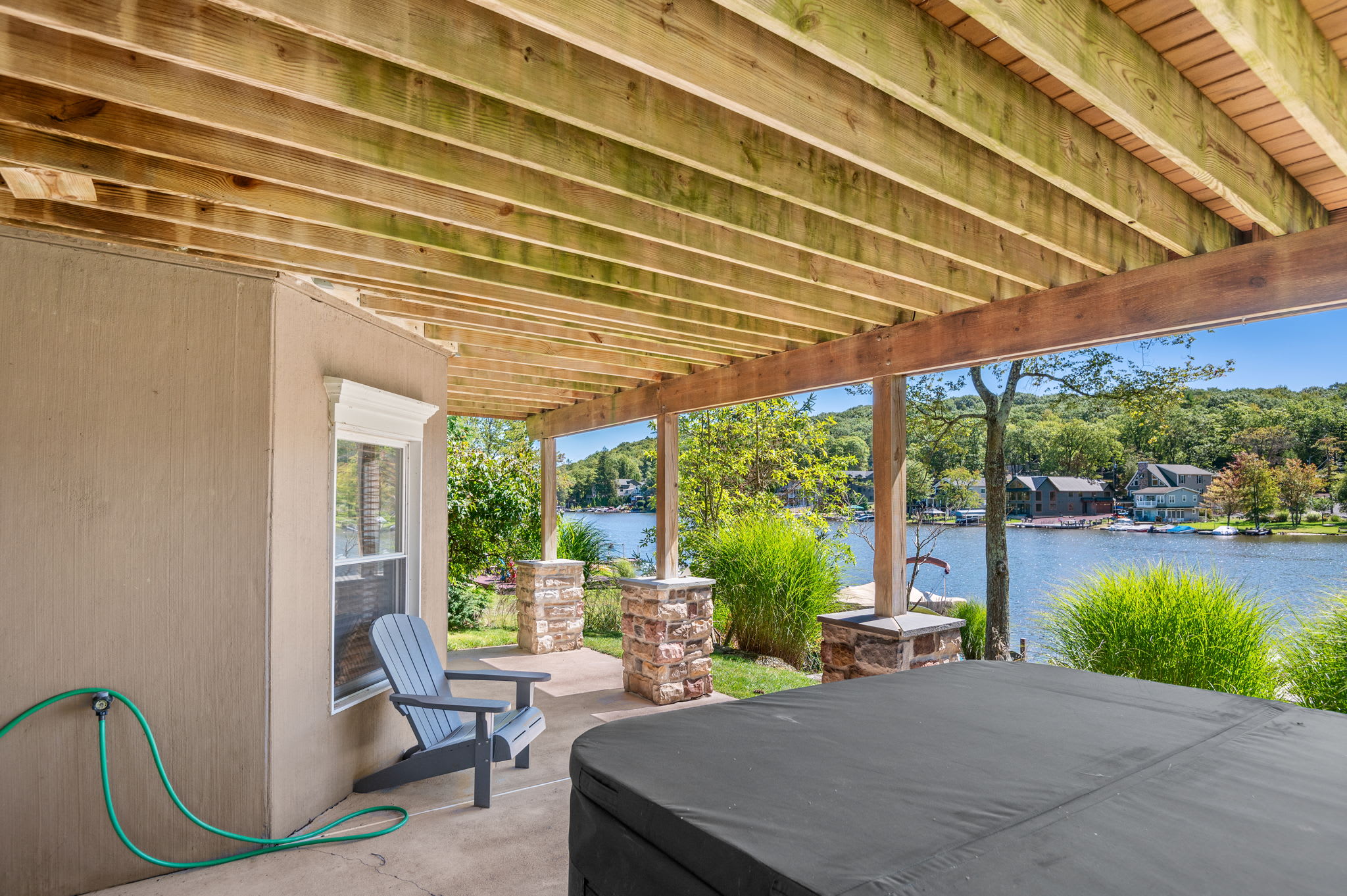 Unwind on the covered patio with lake views and a hot tub just steps away