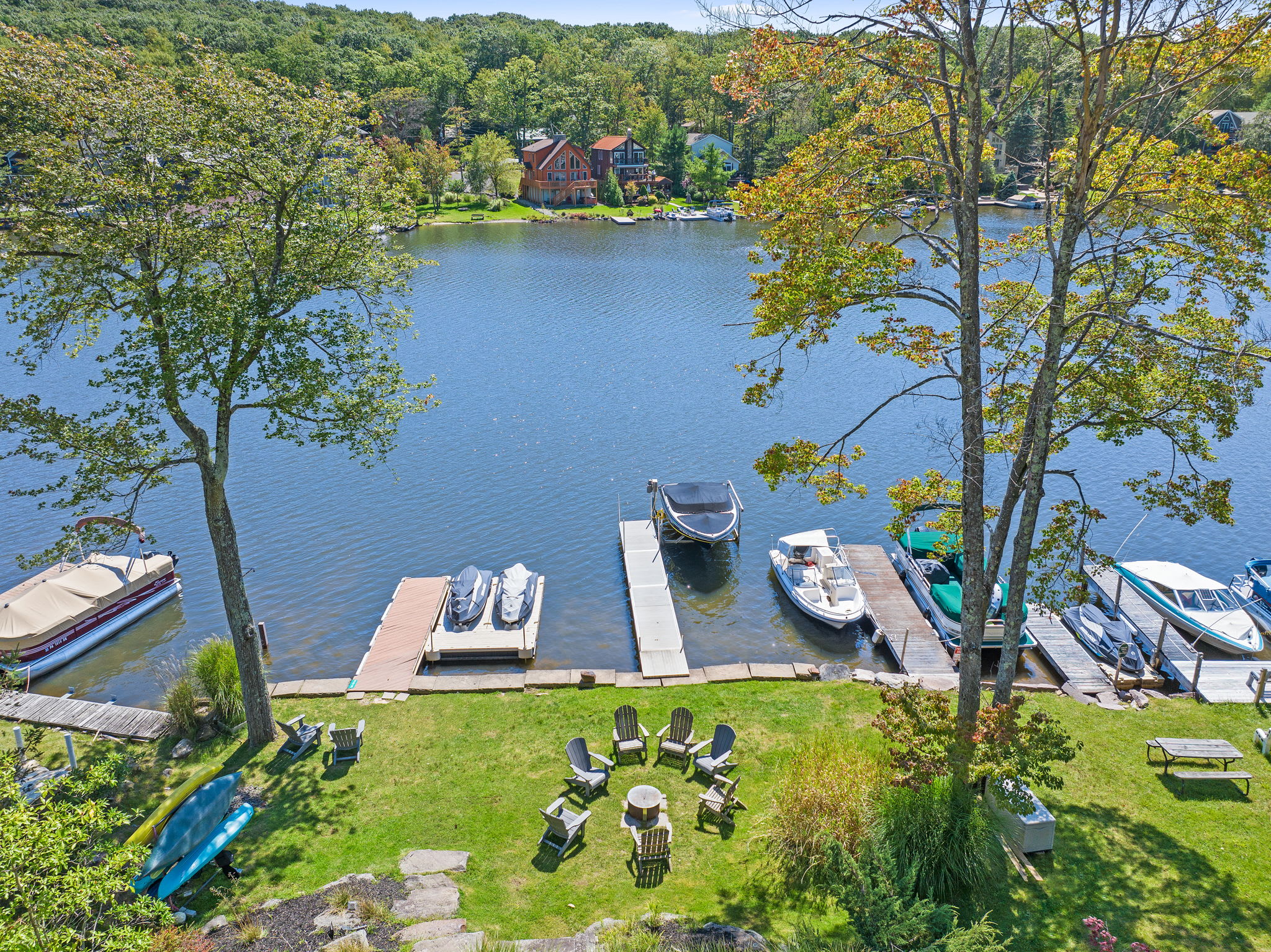 Your own dock and waterfront with Adirondack chairs and room to relax by the lake