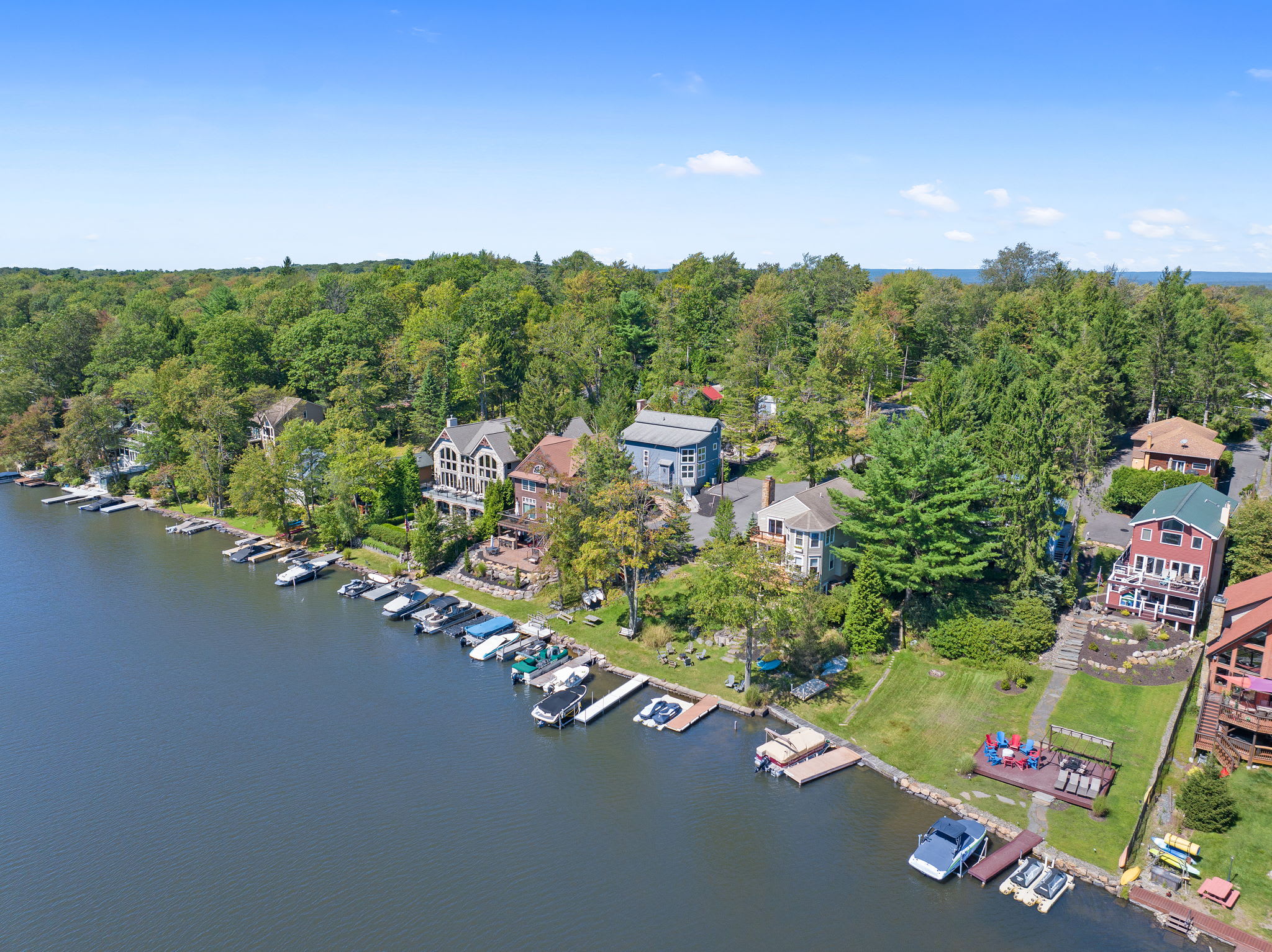 The lakefront neighborhood from above with docks, boats, and lush greenery