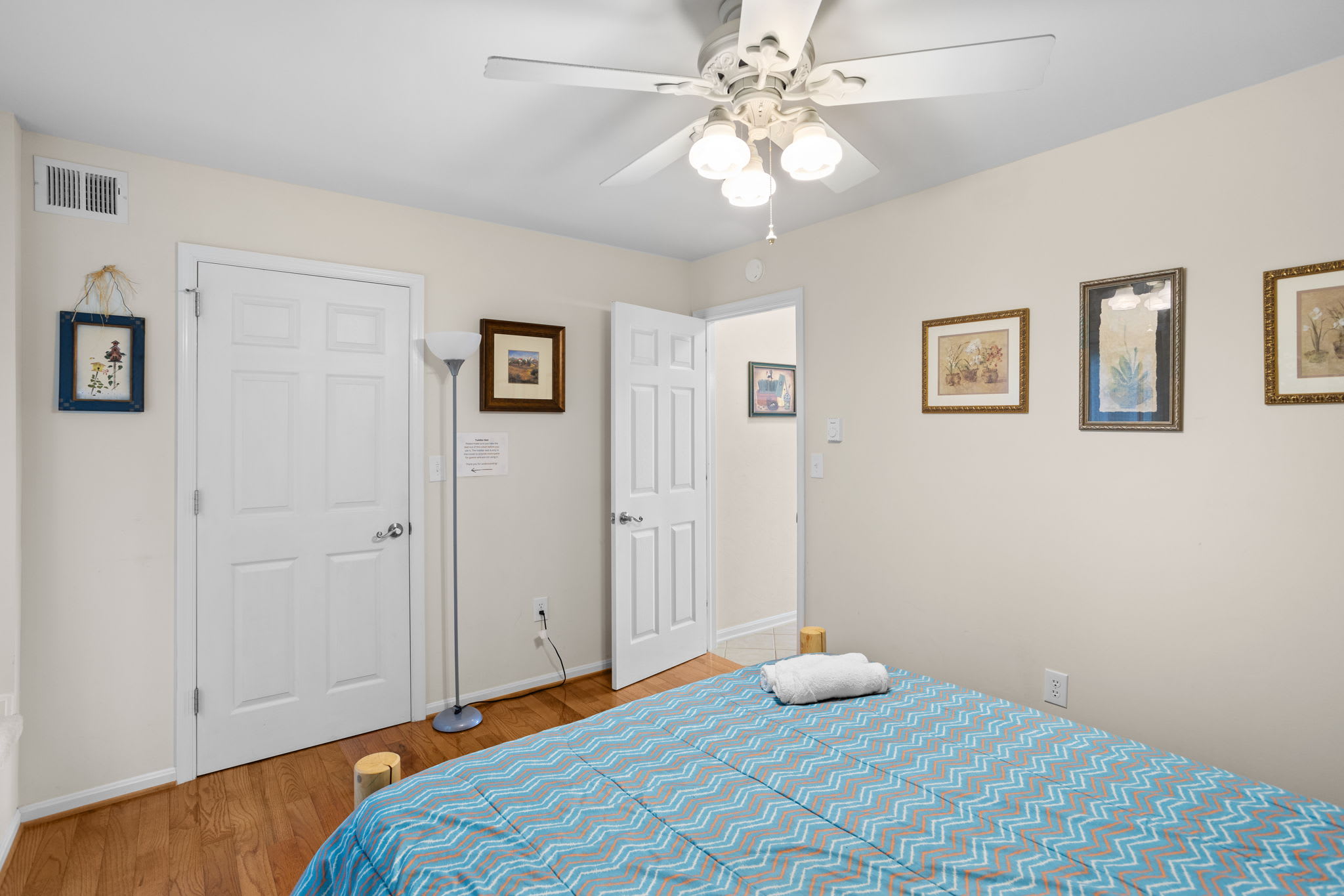 Another charming bedroom with soft bedding and natural light