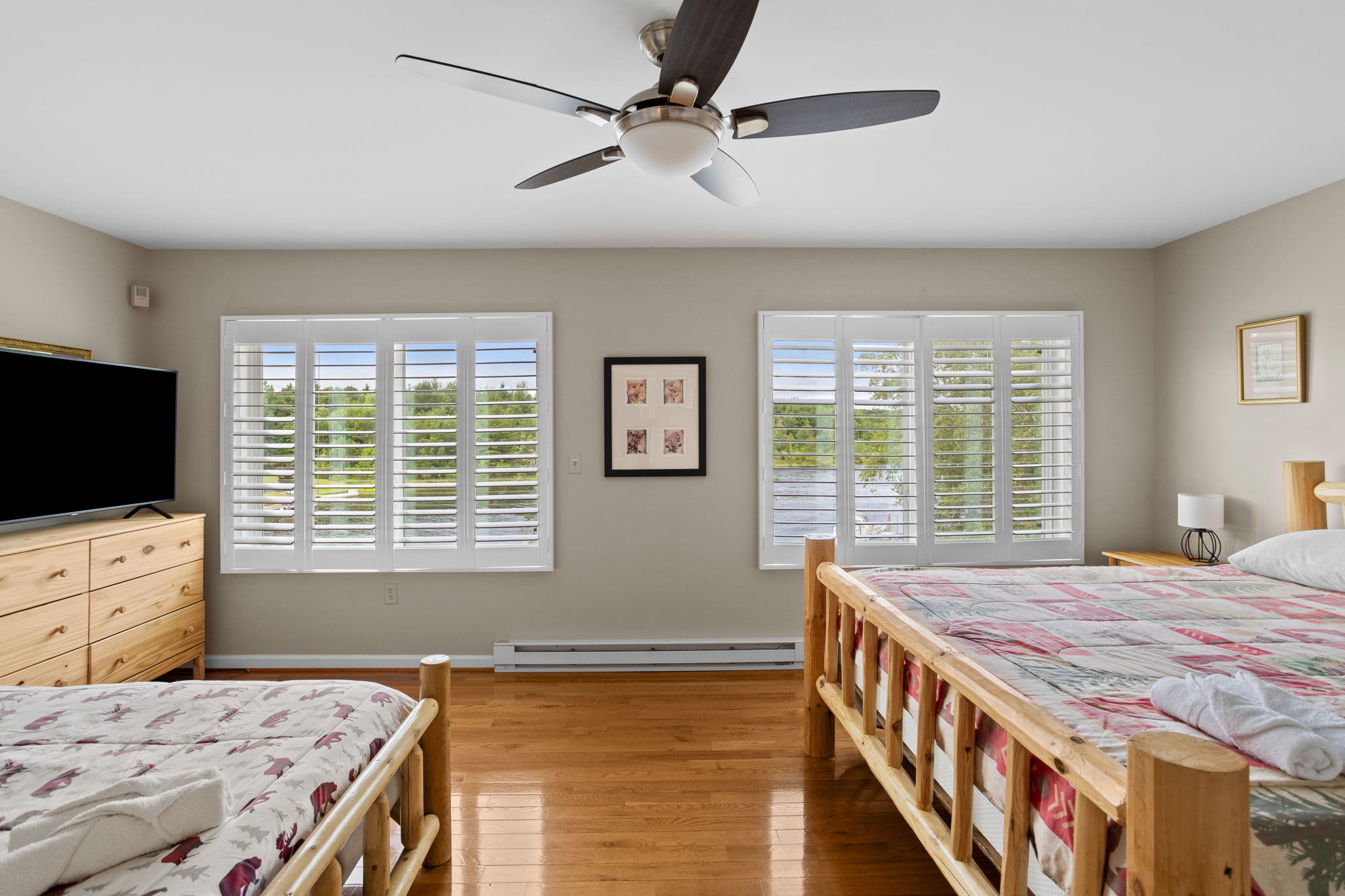Beds with cheerful quilts in this guest bedroom