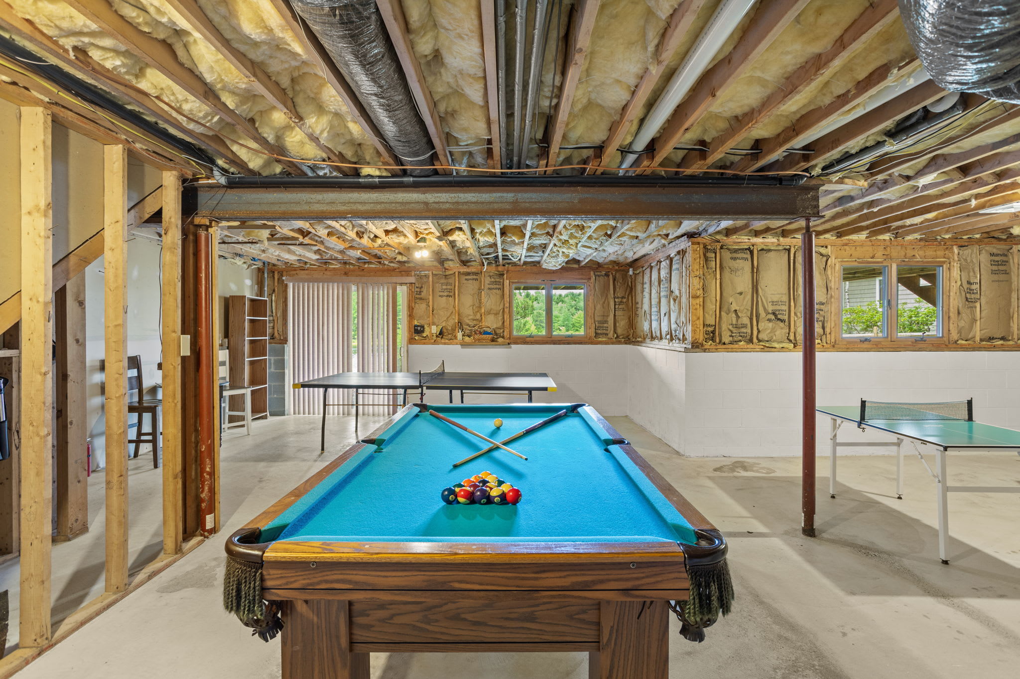 The full game room with pool table and bar area for group fun