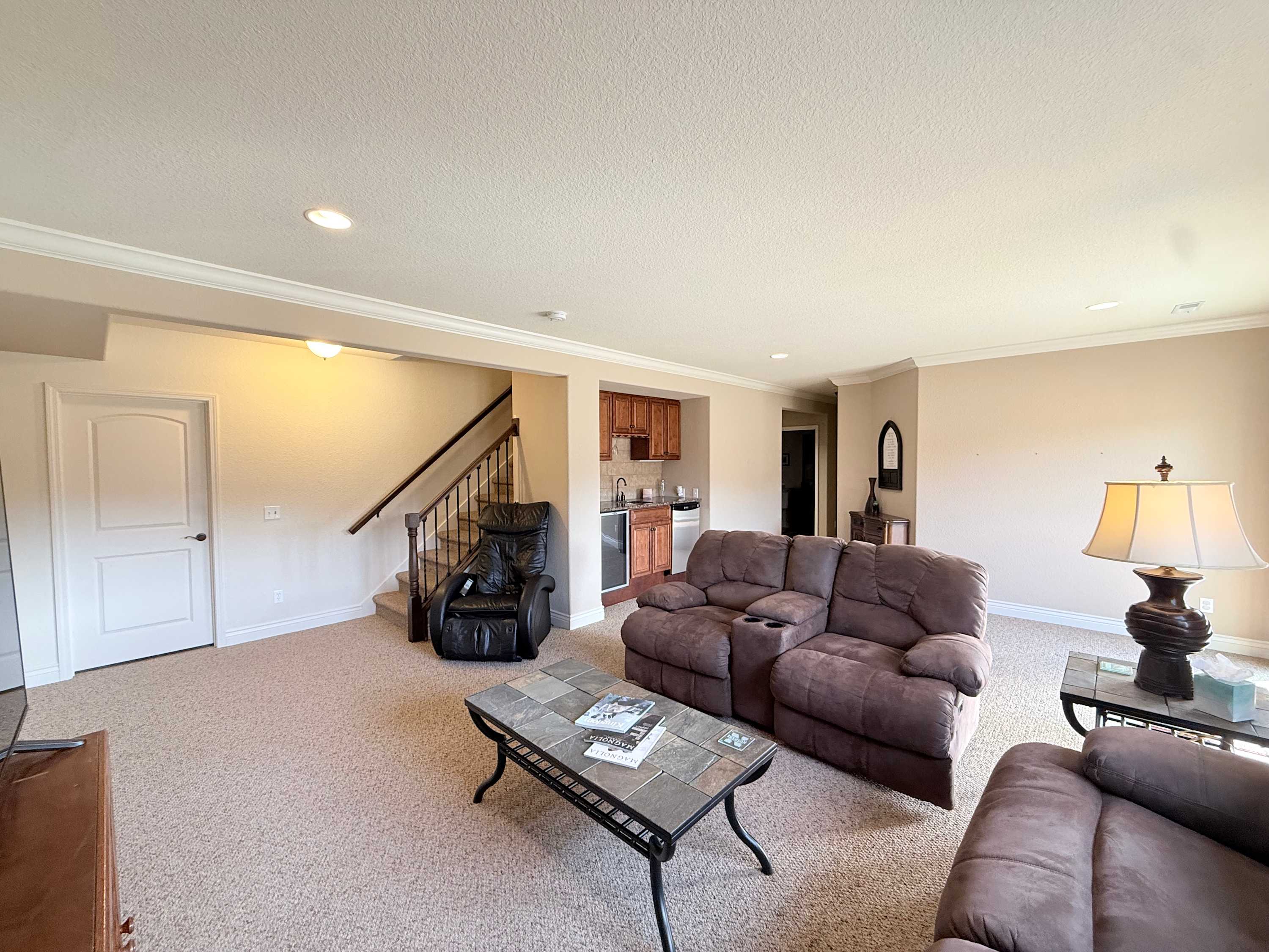 The lower-level den with a smart TV & wet bar is ideal for epic movie nights in​