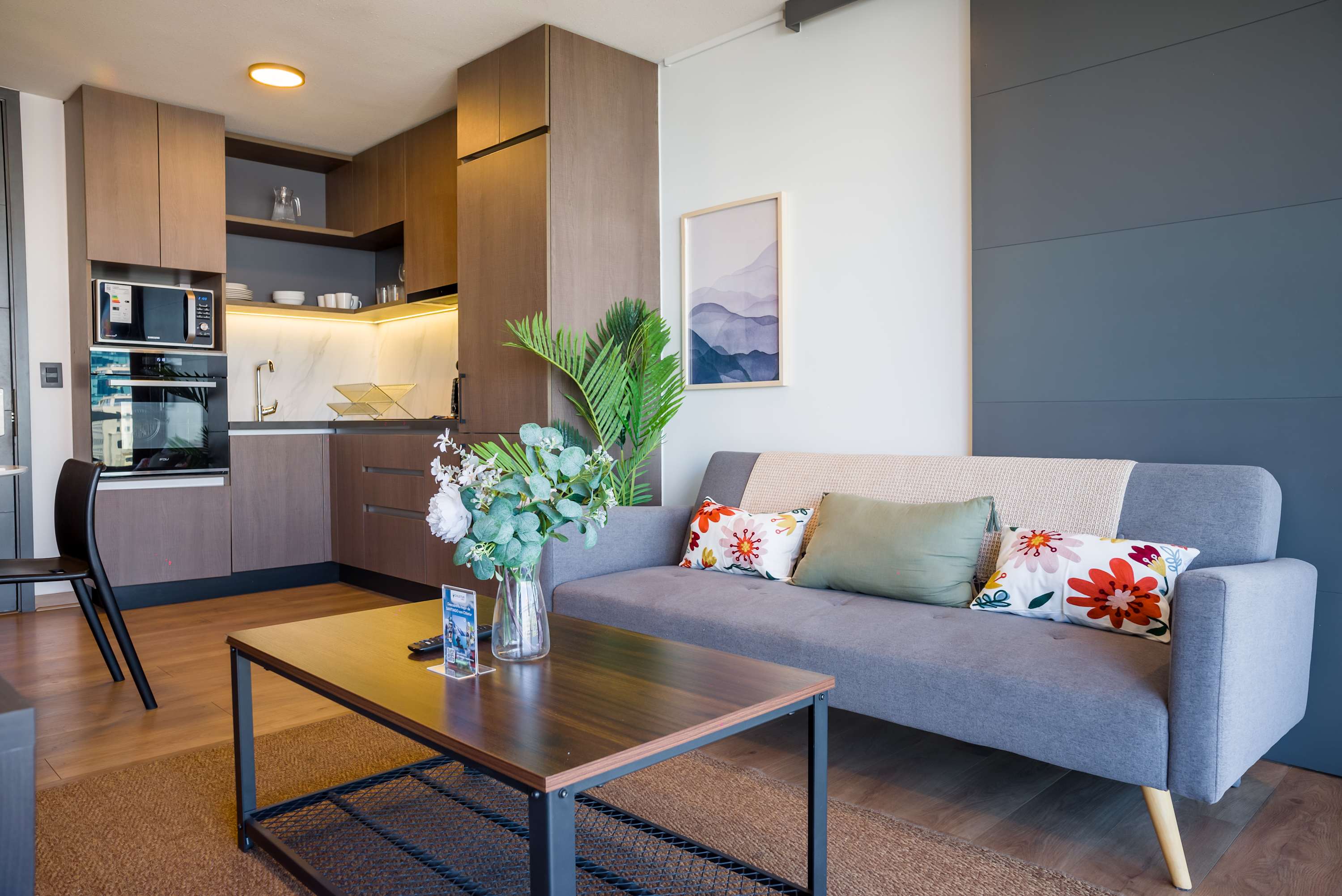 Cozy living area with modern kitchen, perfect for relaxing after a day exploring the city.