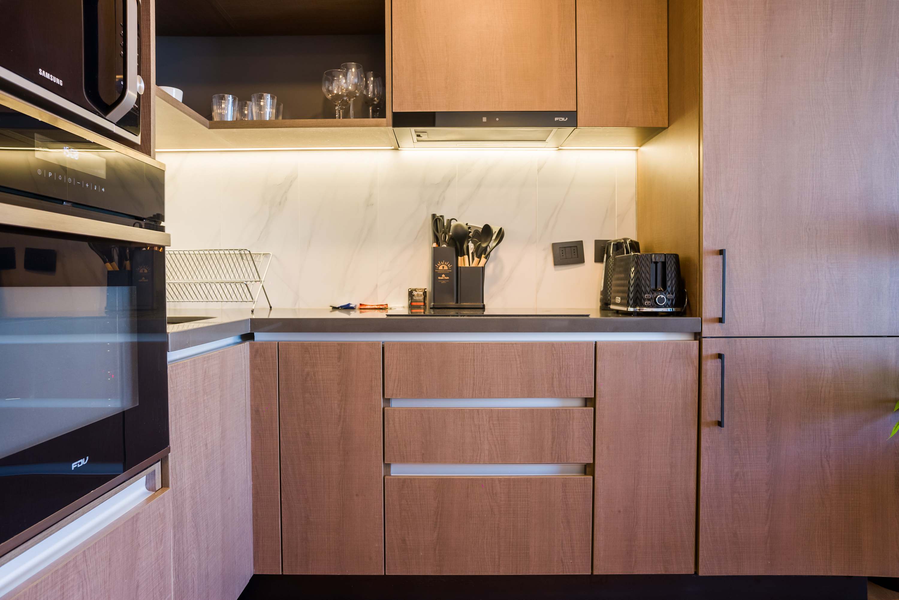 Sleek and modern kitchen with top-notch appliances and ample storage, perfect for culinary enthusiasts.