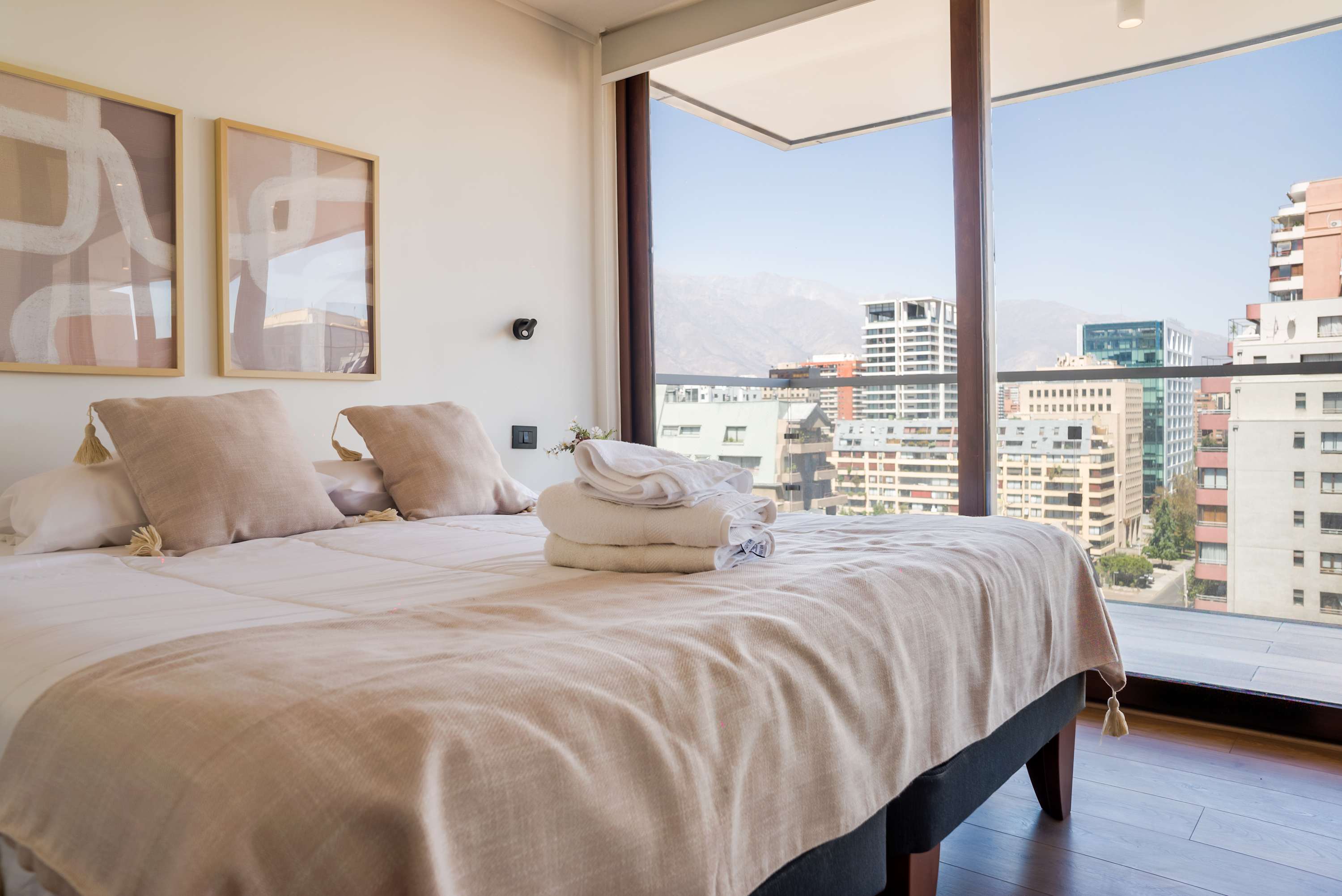 Relax in this cozy bedroom with stunning city views and modern decor, perfect for unwinding after a day of exploring.