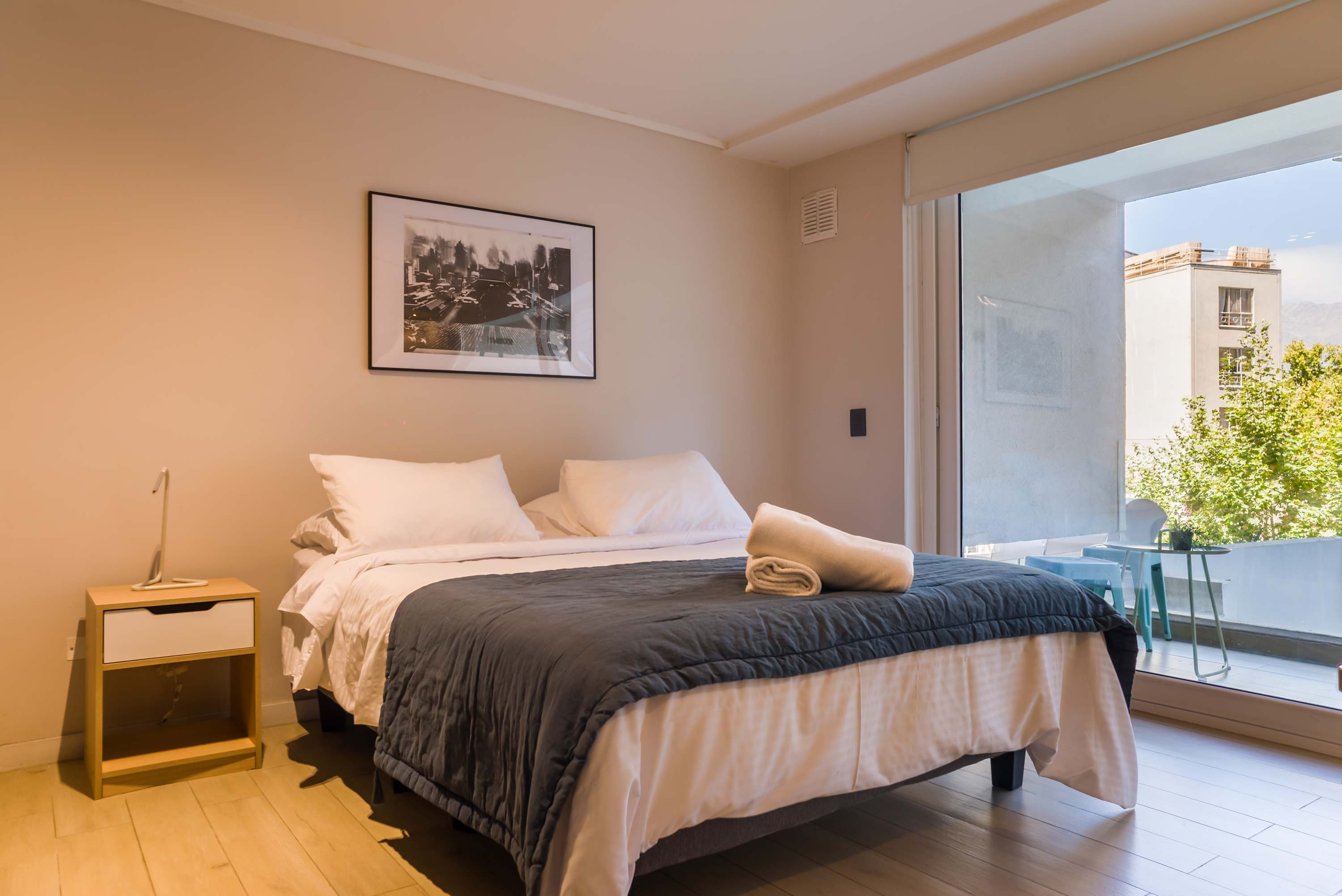 Unwind in this inviting bedroom with a private balcony and enjoy the lush green views.