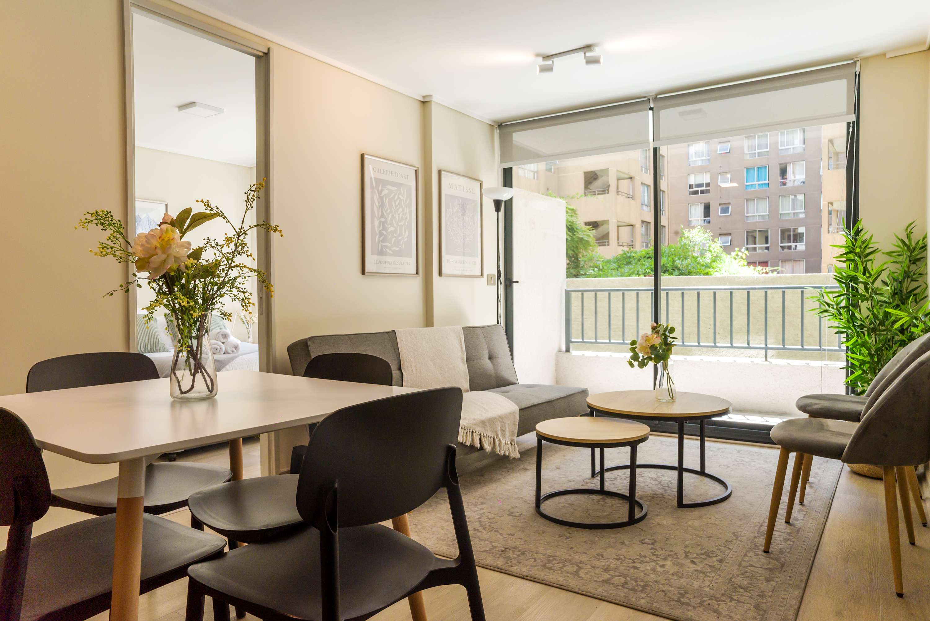Cozy living area with natural light and modern decor, perfect for relaxing after exploring the city.