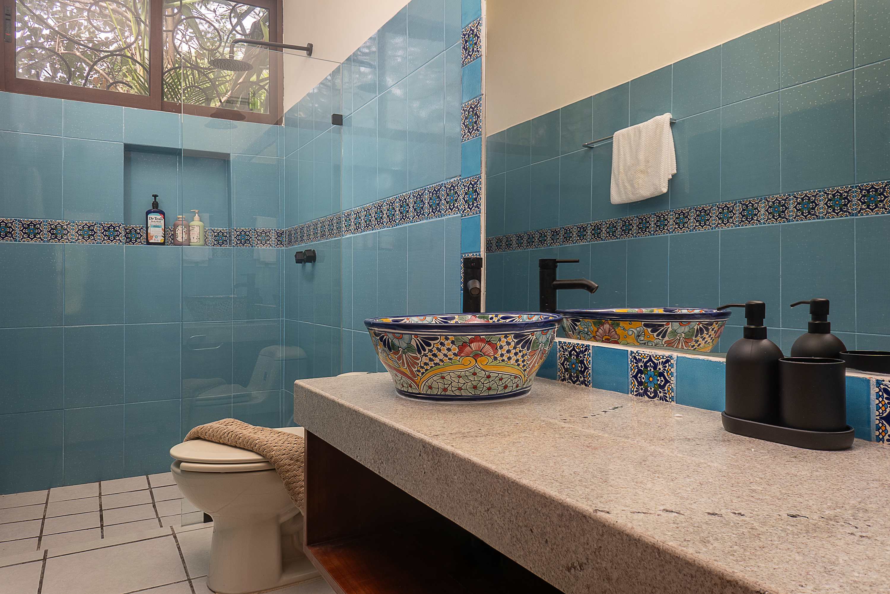Bathroom #3 A beautifully crafted Mexican artisanal-style bathroom with hand-painted Talavera sinks, colorful tiles, and unique handmade details.