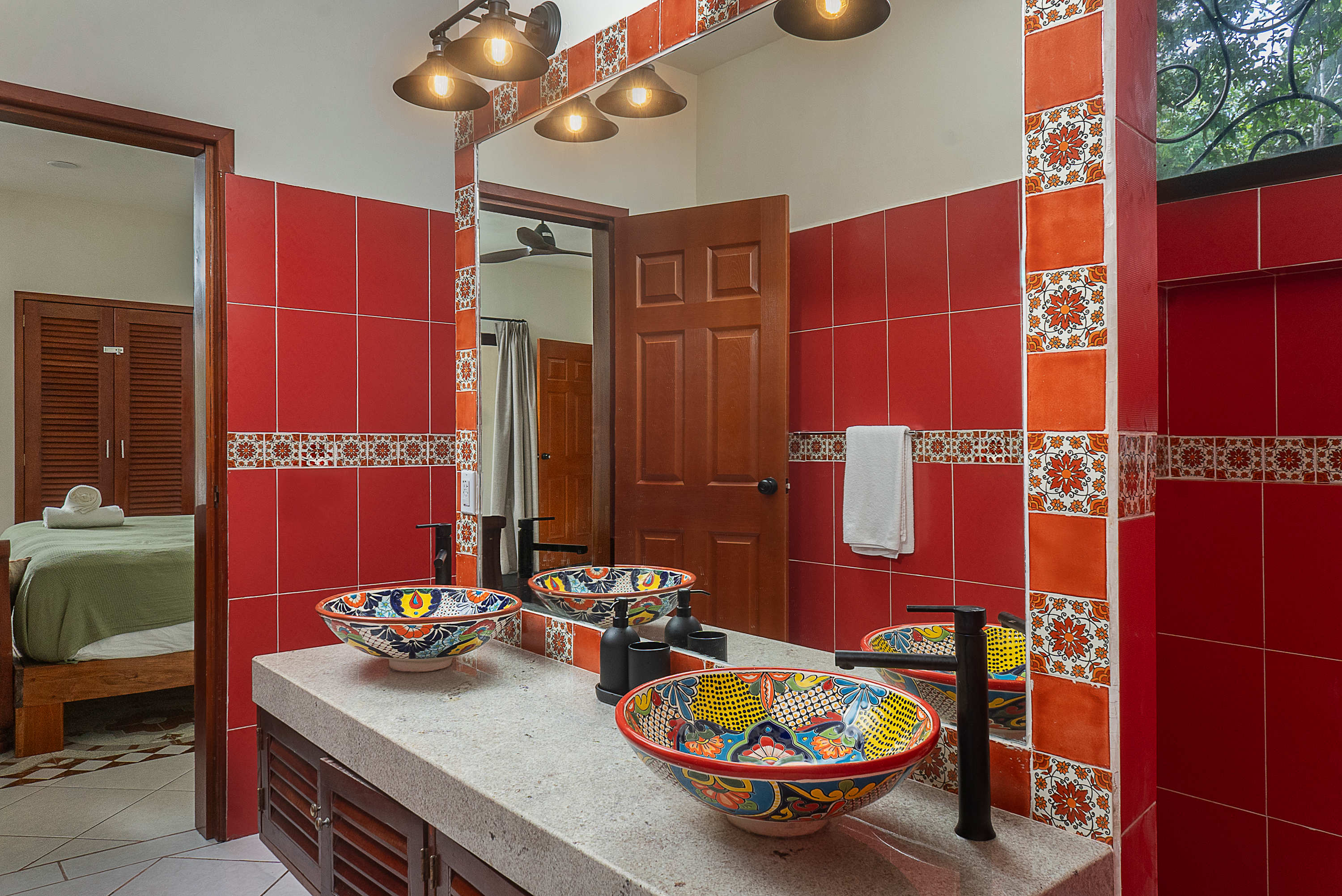 Full bathroom #1 
Mexican artisanal–style bathroom featuring hand-painted Talavera sinks, vibrant tiles, and handcrafted decorative details.
