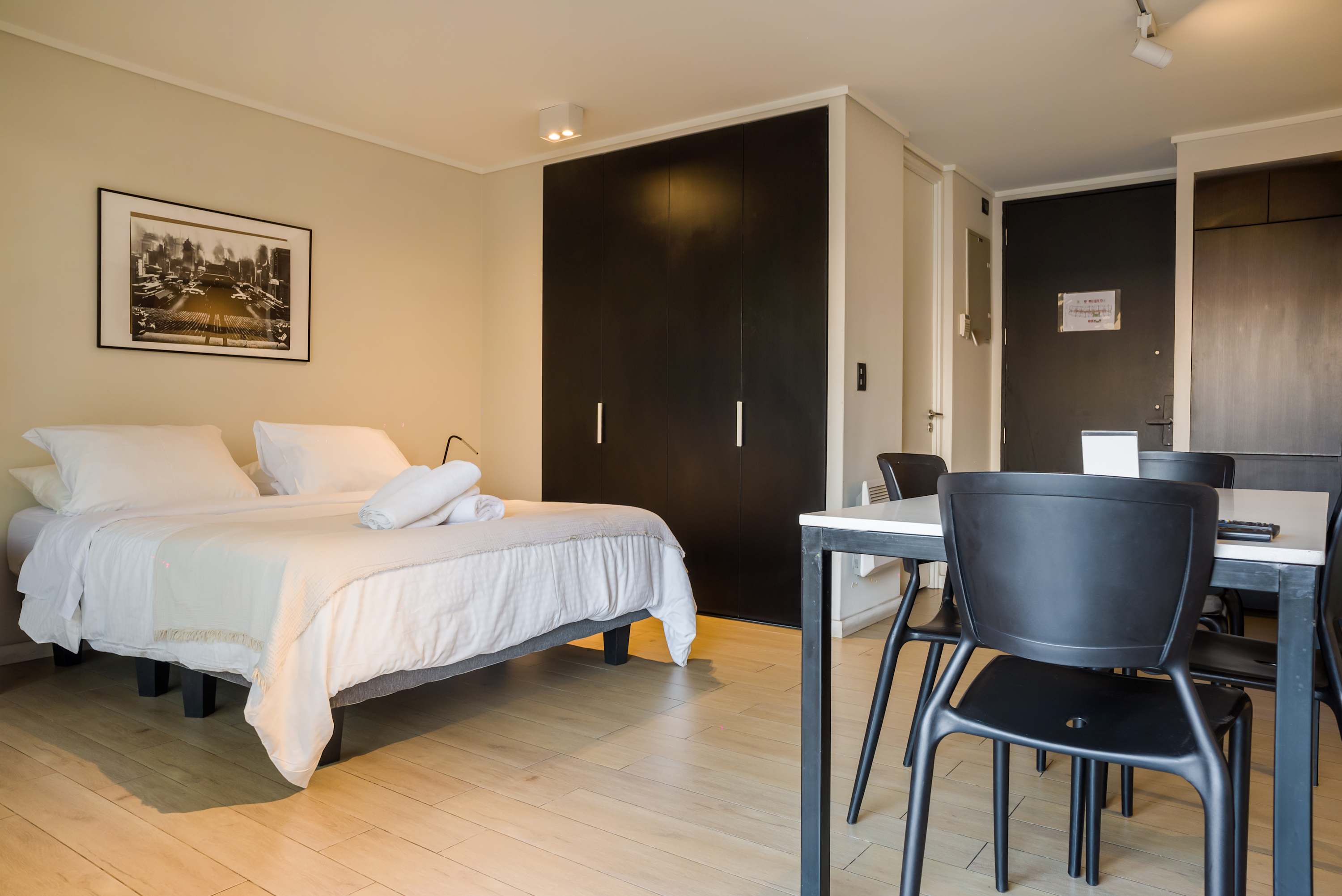 Cozy studio with modern decor and ample storage, perfect for a comfortable stay in the heart of the city.