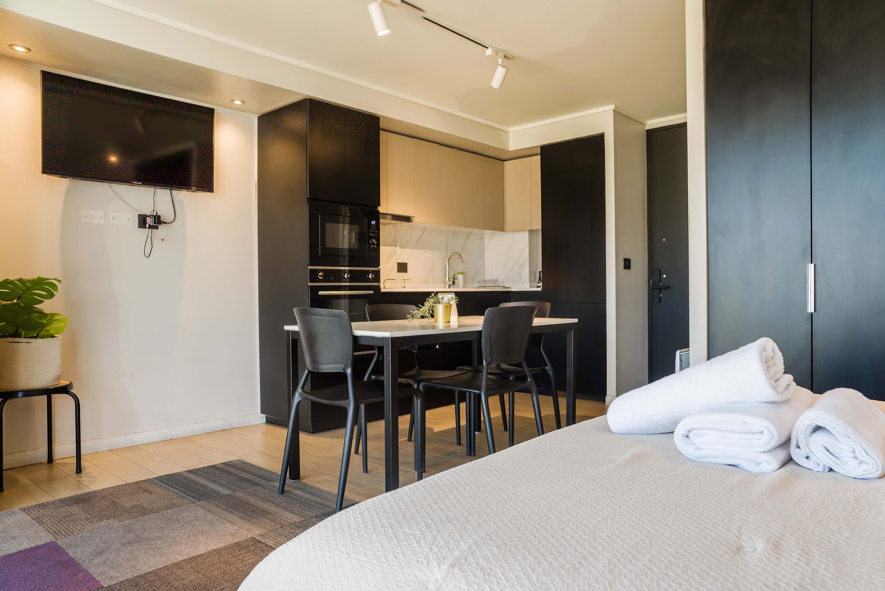Cozy studio with a sleek kitchen and dining area, perfect for a comfortable stay in the heart of Chile.