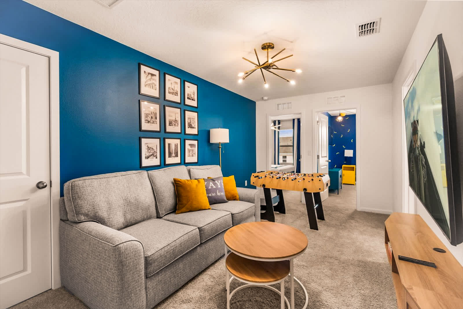 Enjoy a fun game night in this stylish room with a foosball table and cozy seating area.