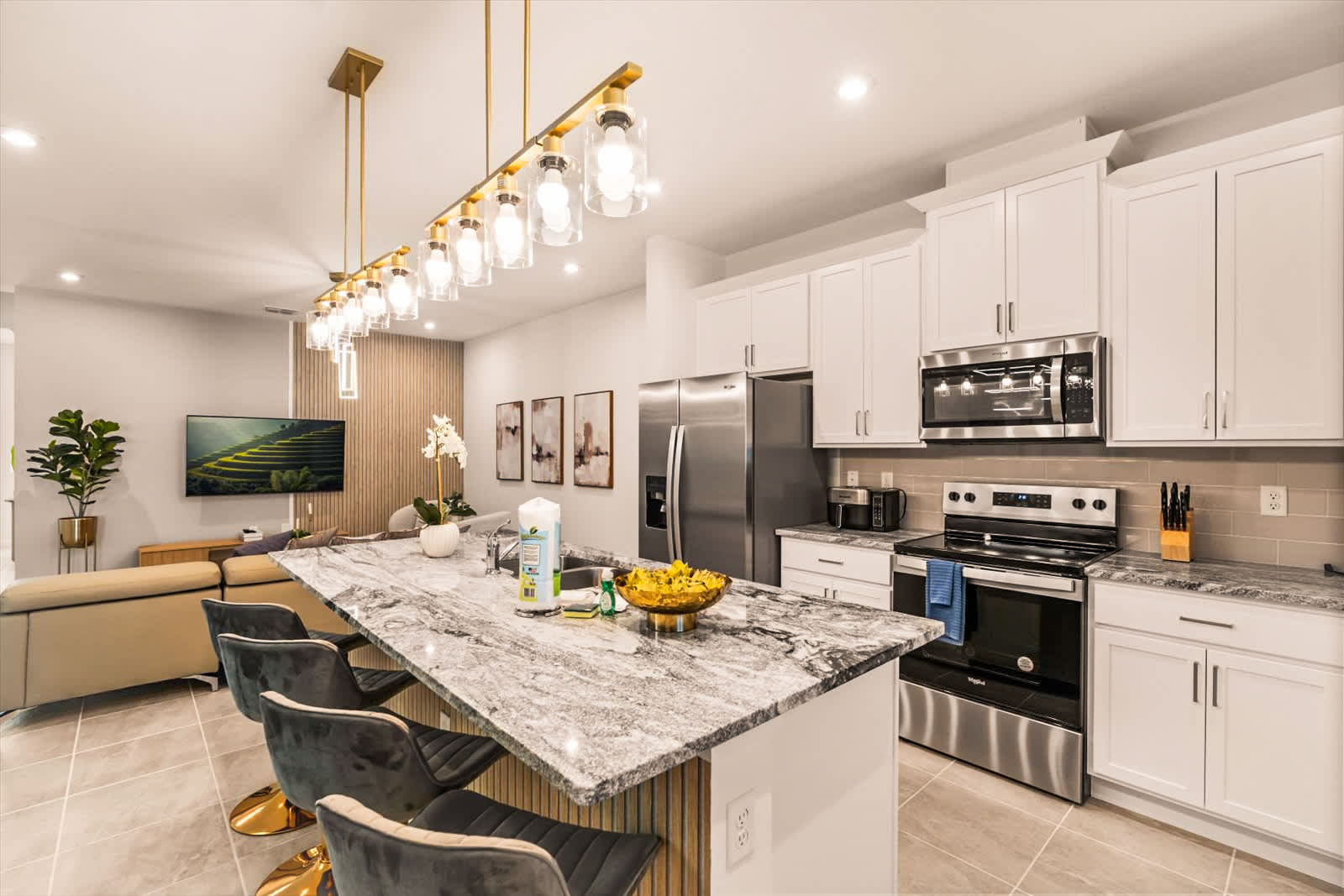 Spacious modern kitchen with sleek appliances and a cozy living area perfect for entertaining.