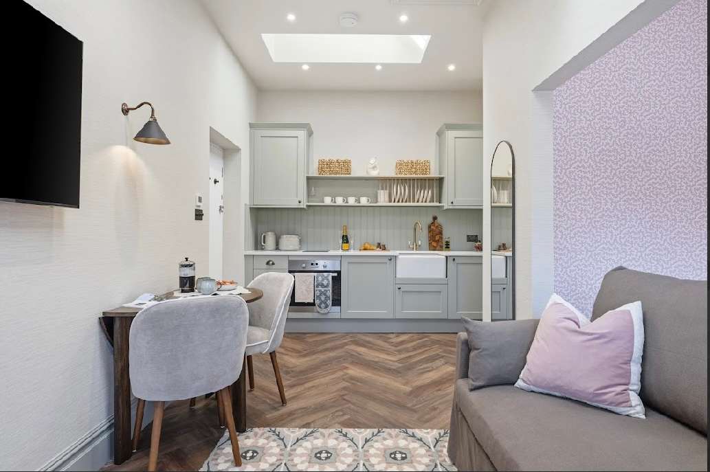 Bright, open-plan lounge with kitchenette.