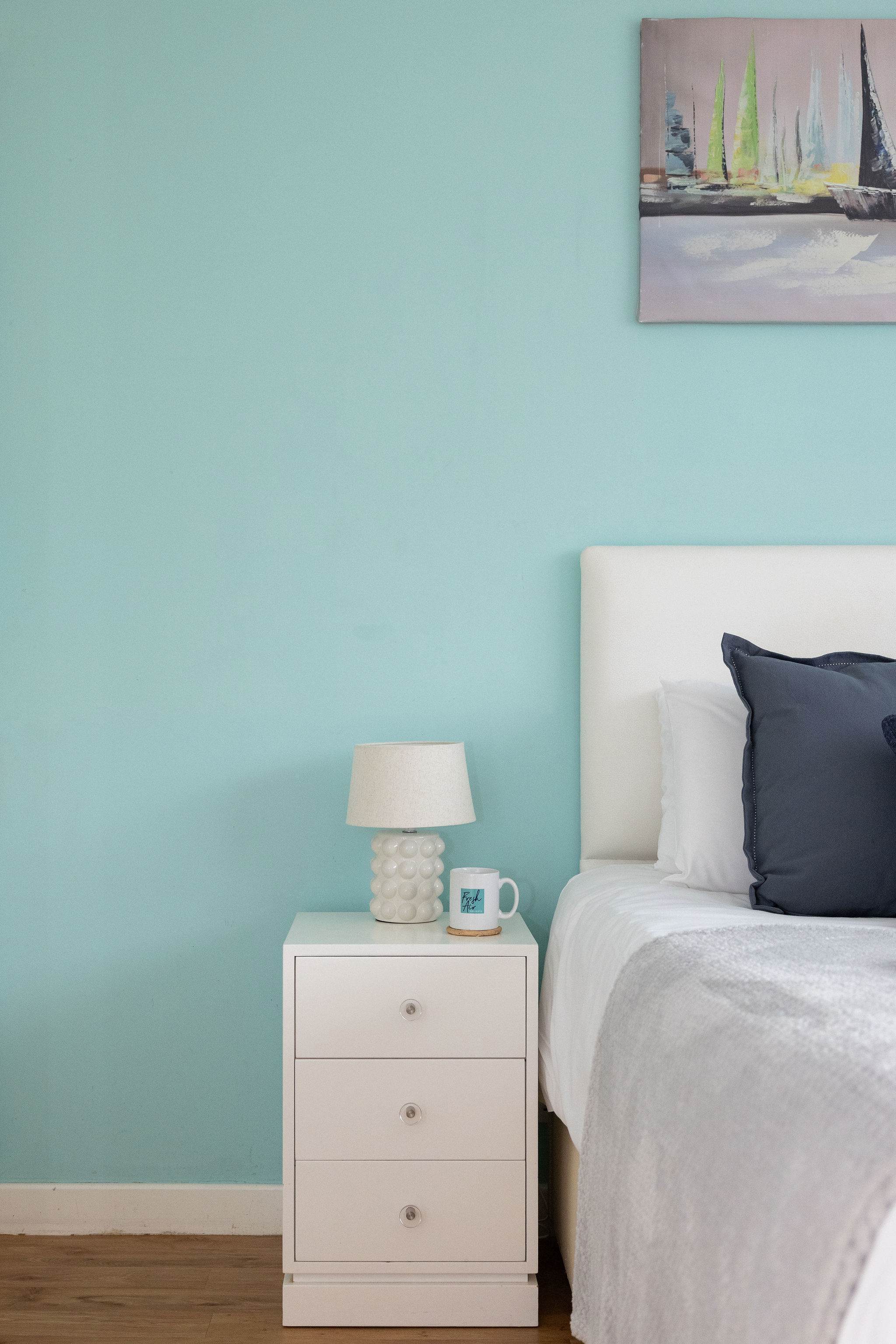 Bright bedside space with soft lighting and handy storage for added comfort and convenience.