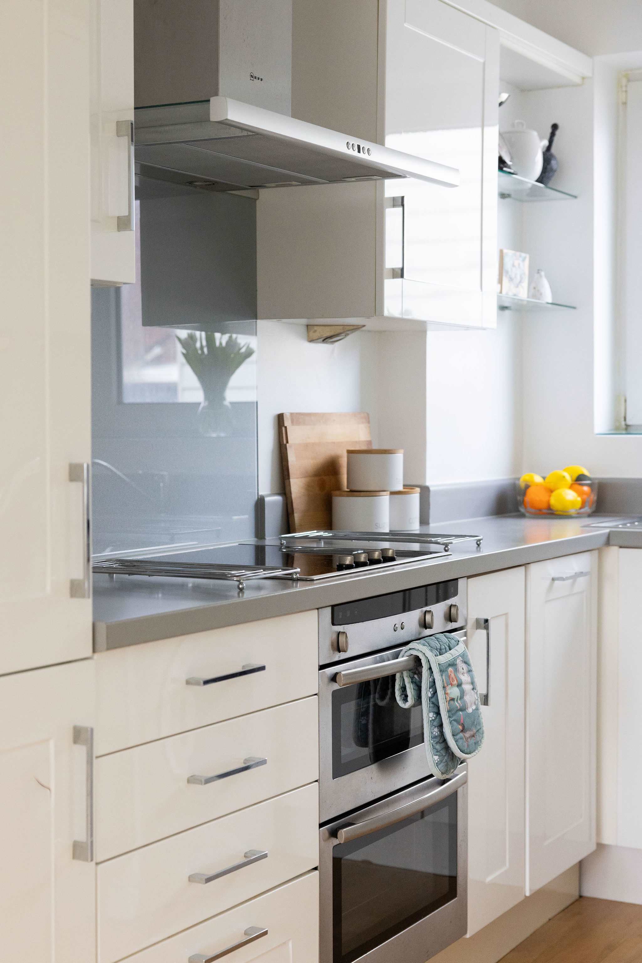 Well-equipped kitchen area with oven, hob, and ample storage, ideal for preparing delicious meals during your seaside getaway.