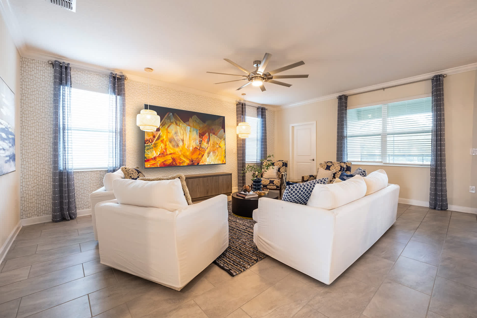 Relax in this stylish living room with plush seating and vibrant artwork, perfect for gatherings.