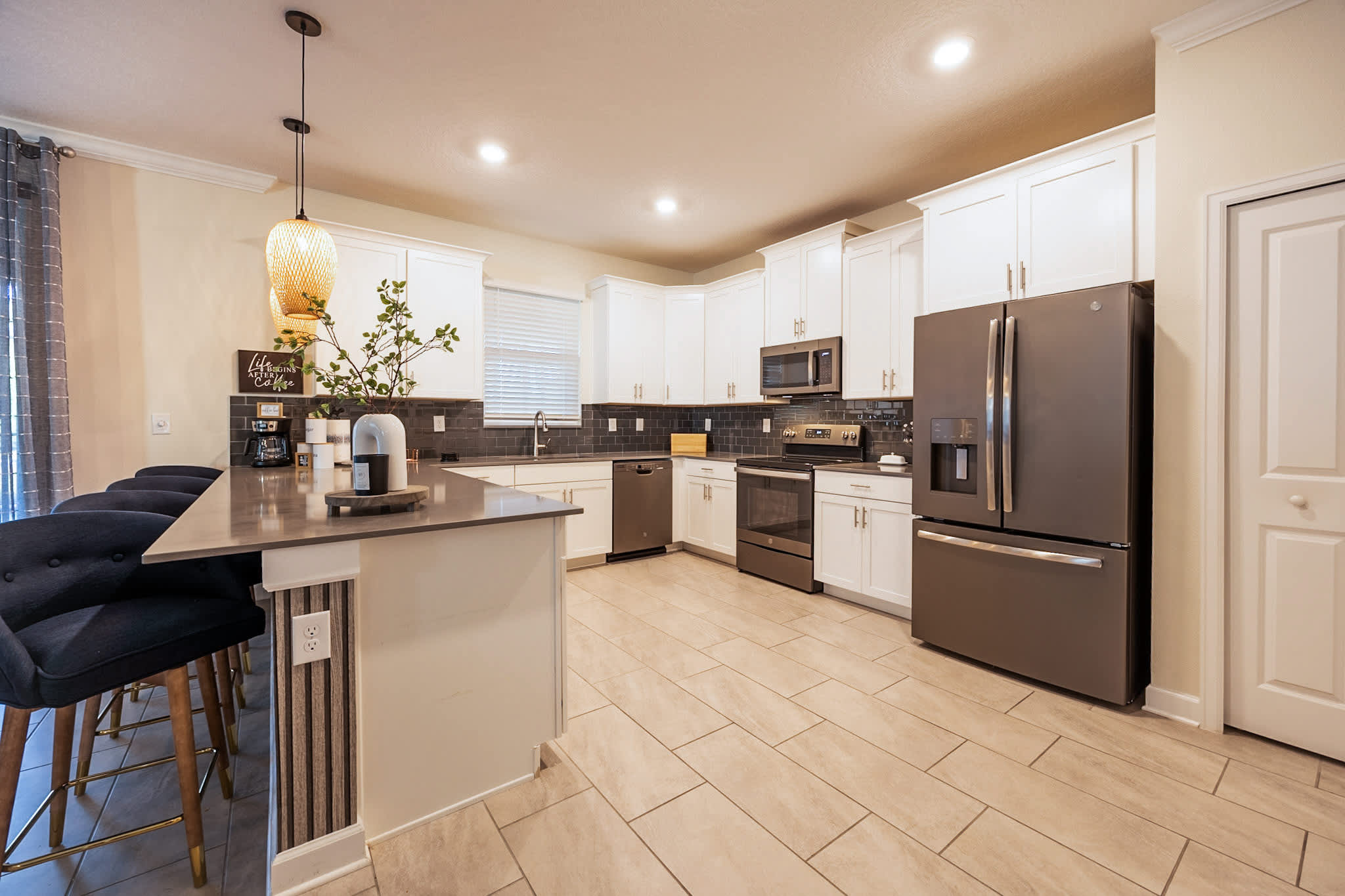 Spacious modern kitchen with sleek appliances and a cozy breakfast bar, perfect for family gatherings.