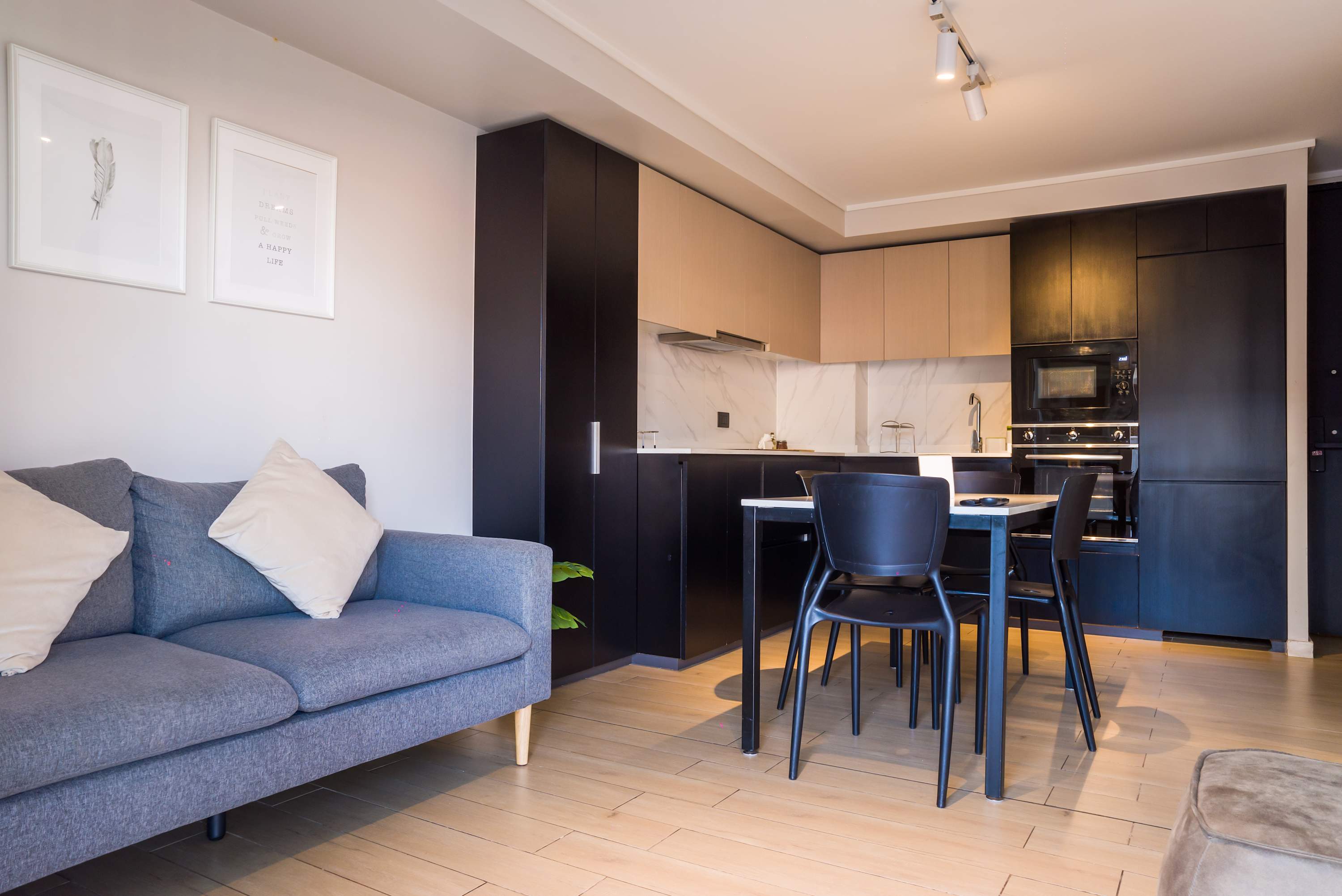 Modern living area with stylish kitchen and cozy seating, perfect for a city retreat.