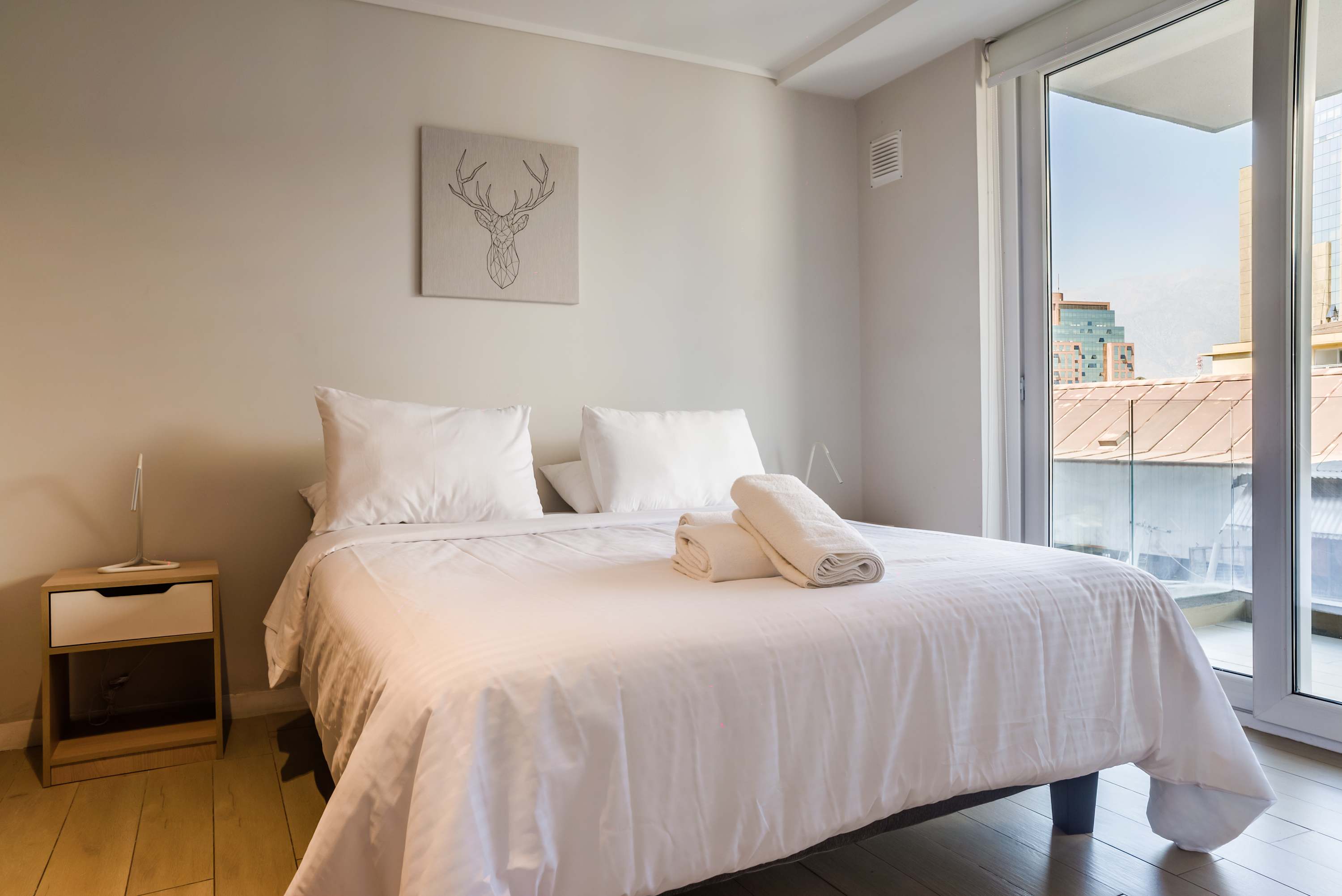 Relax in this cozy bedroom with city views and modern decor, perfect for a tranquil stay in the heart of Santiago.