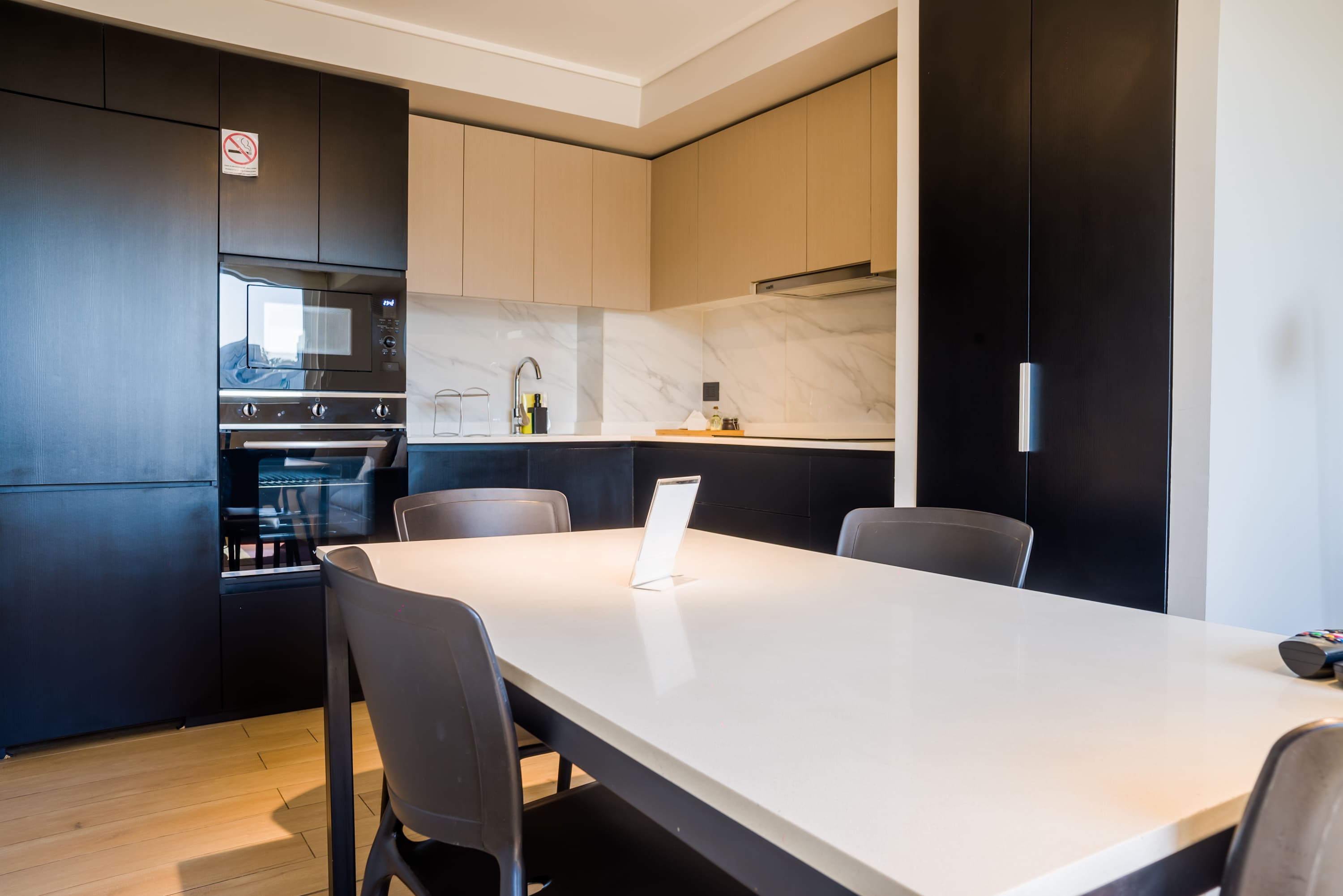 Experience culinary delight in this modern kitchen with sleek design and ample seating.