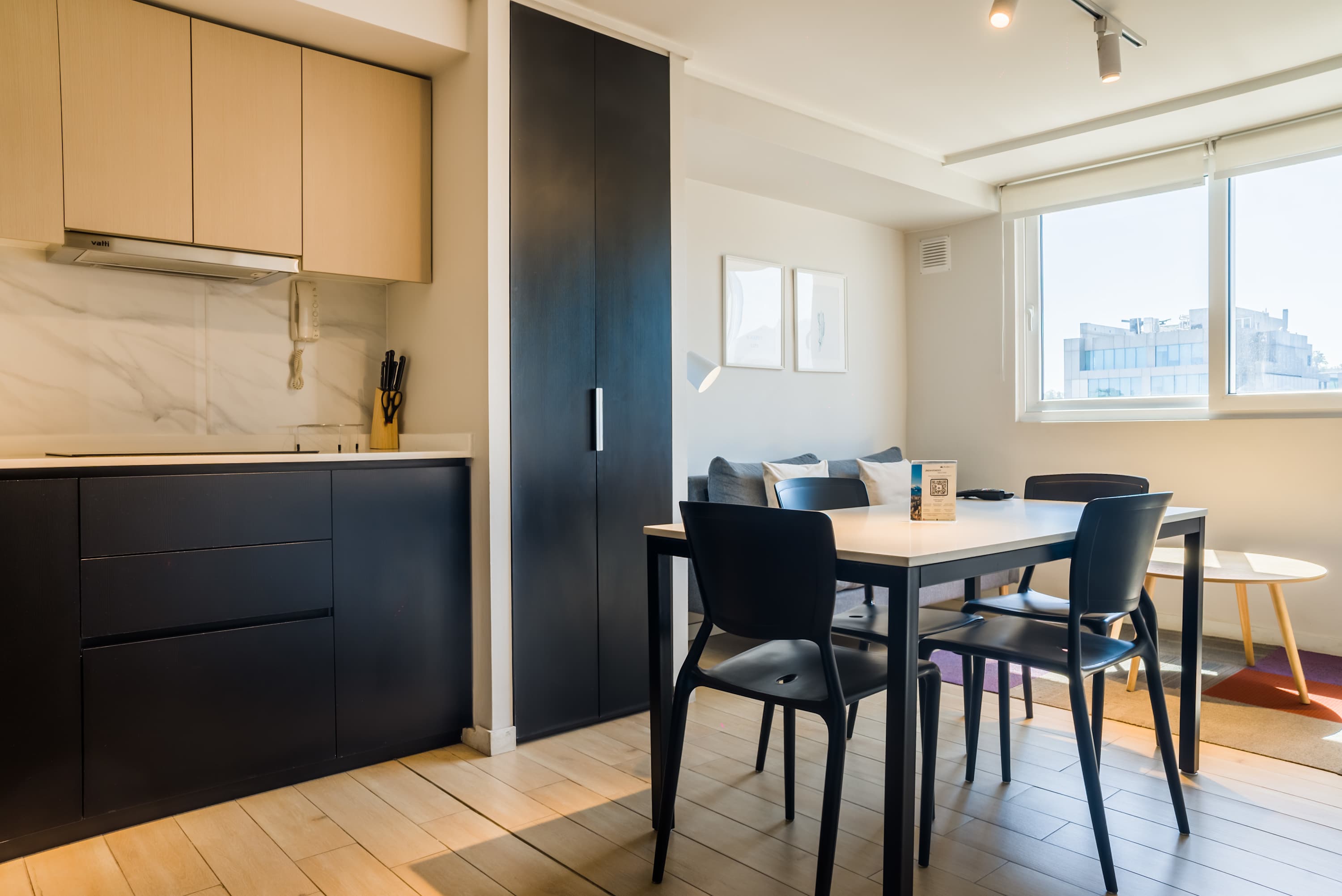 Bright and modern kitchen with ample natural light, perfect for cozy meals in a stylish setting.