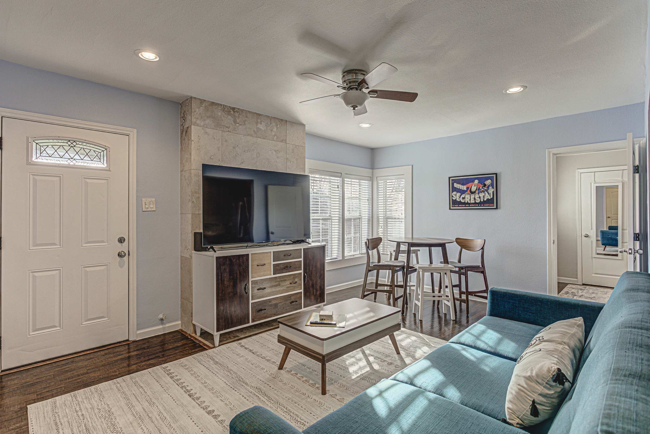 Modern living room with a sleek blue sofa.