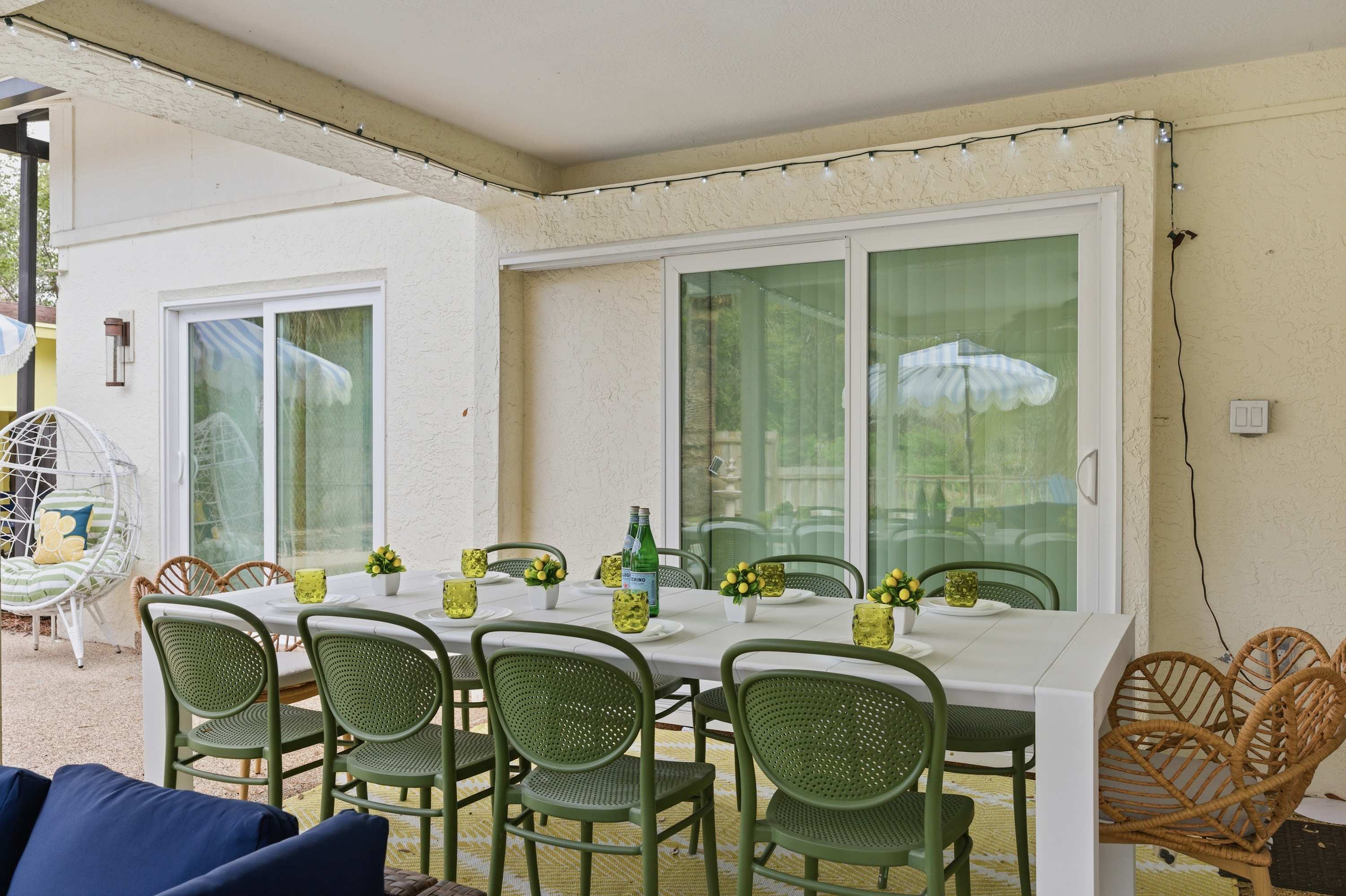 Bright covered patio w/ dining table & chairs, great for outdoor meals.