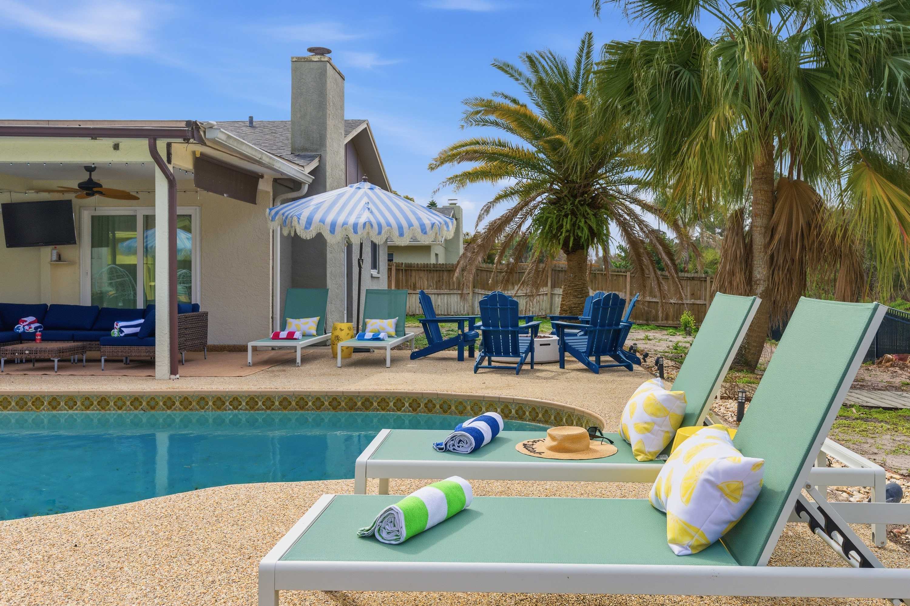Poolside loungers under the palms — made for lazy sunny afternoons.