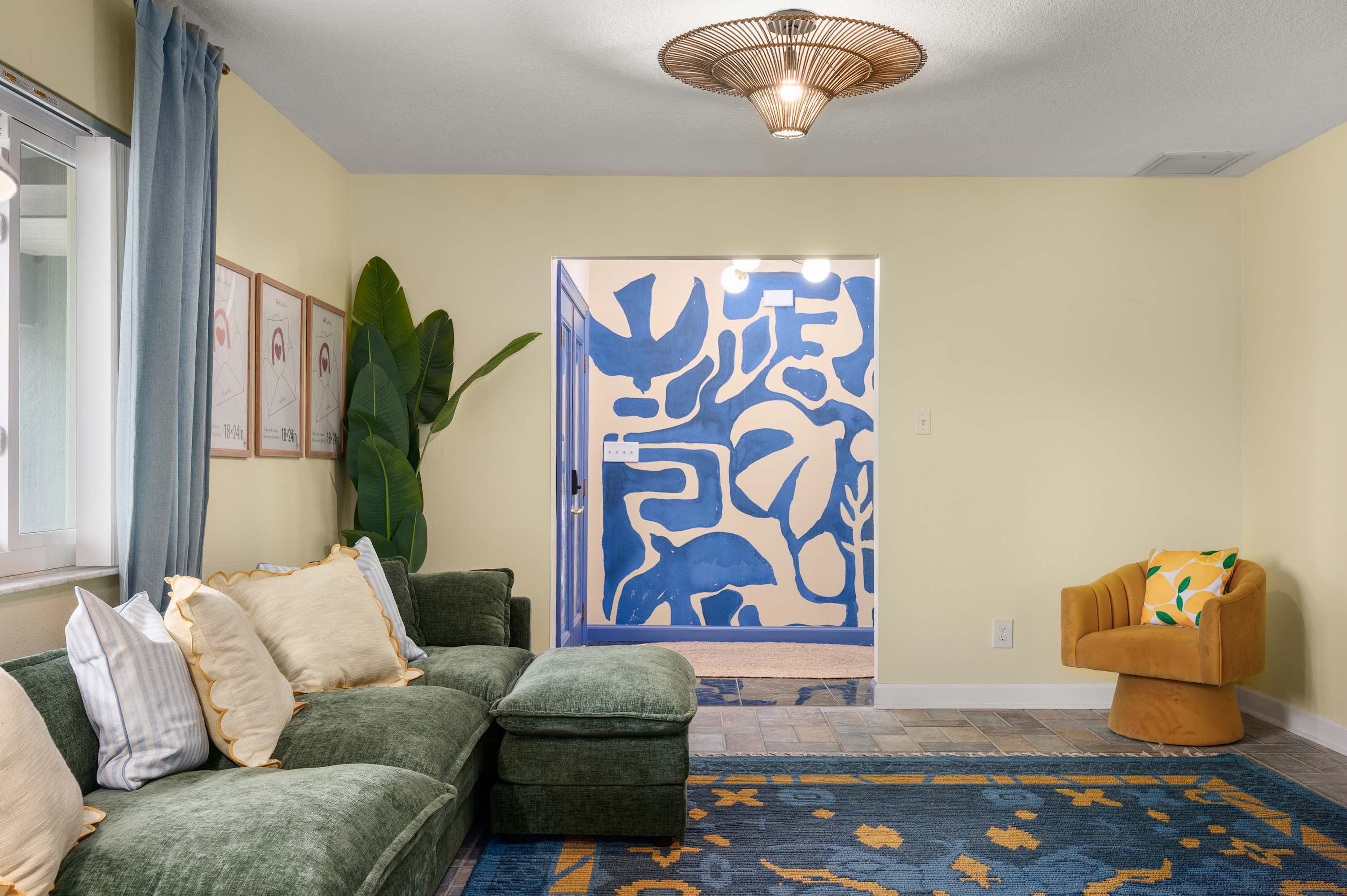 Cozy sitting area w/ bold blue artwork, sofa & soft natural light.