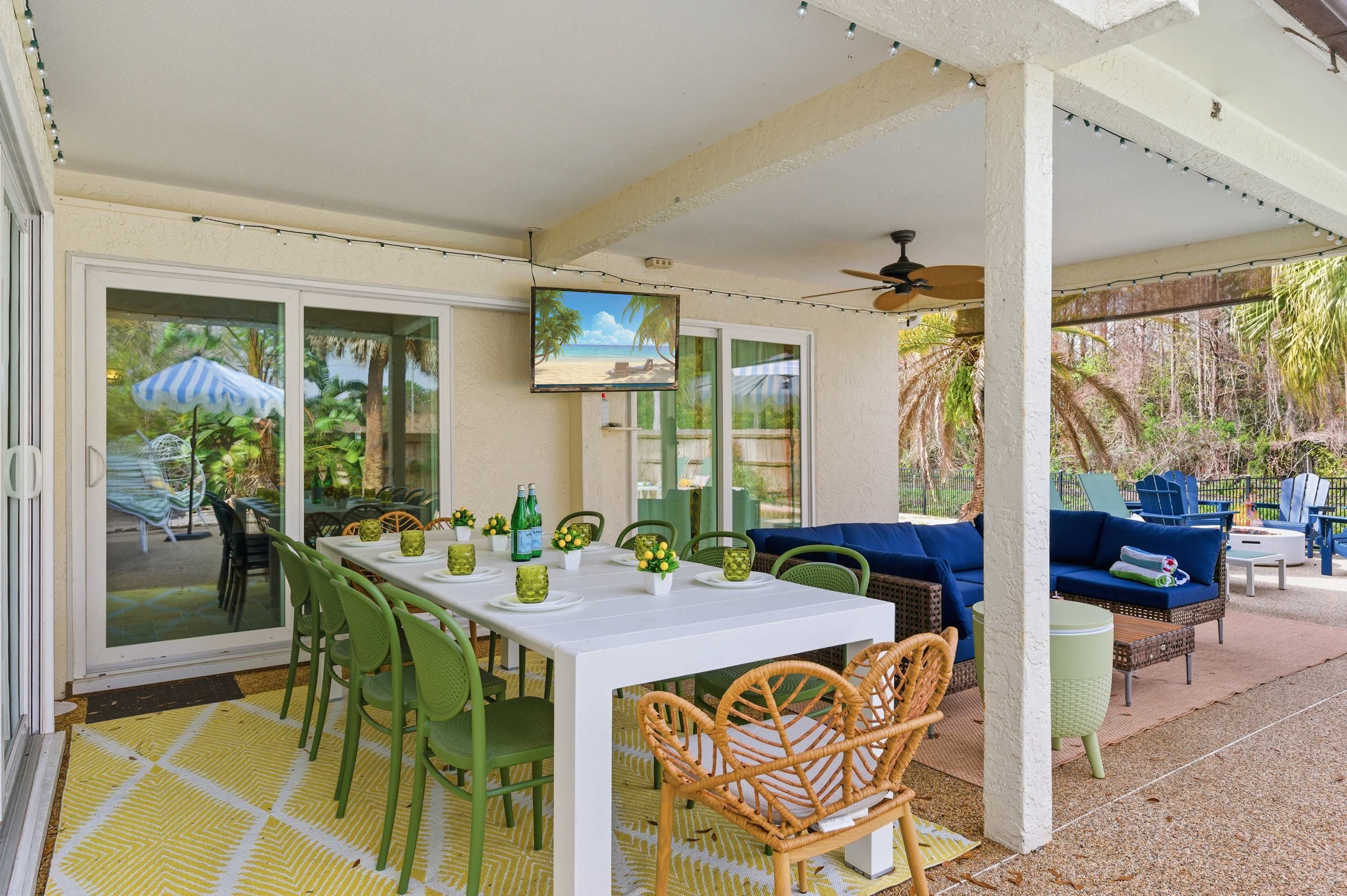 Covered outdoor game area w/ foosball table, ceiling fan & garden views.