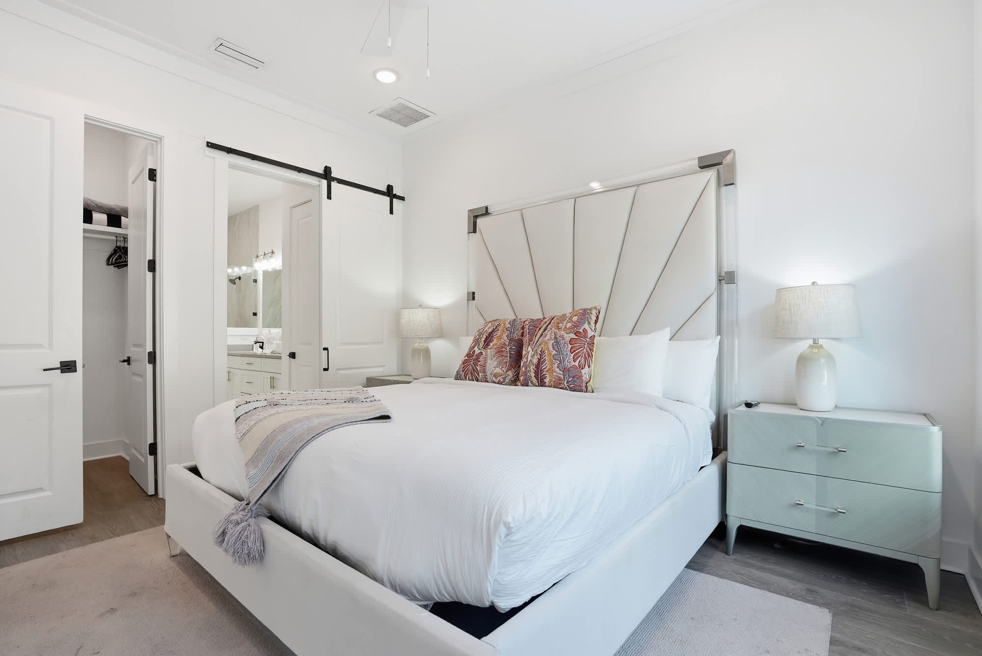 120 Dune Drive – Bedroom with a king-sized bed, decorative pillows, nightstand, closet, and bathroom doorway.