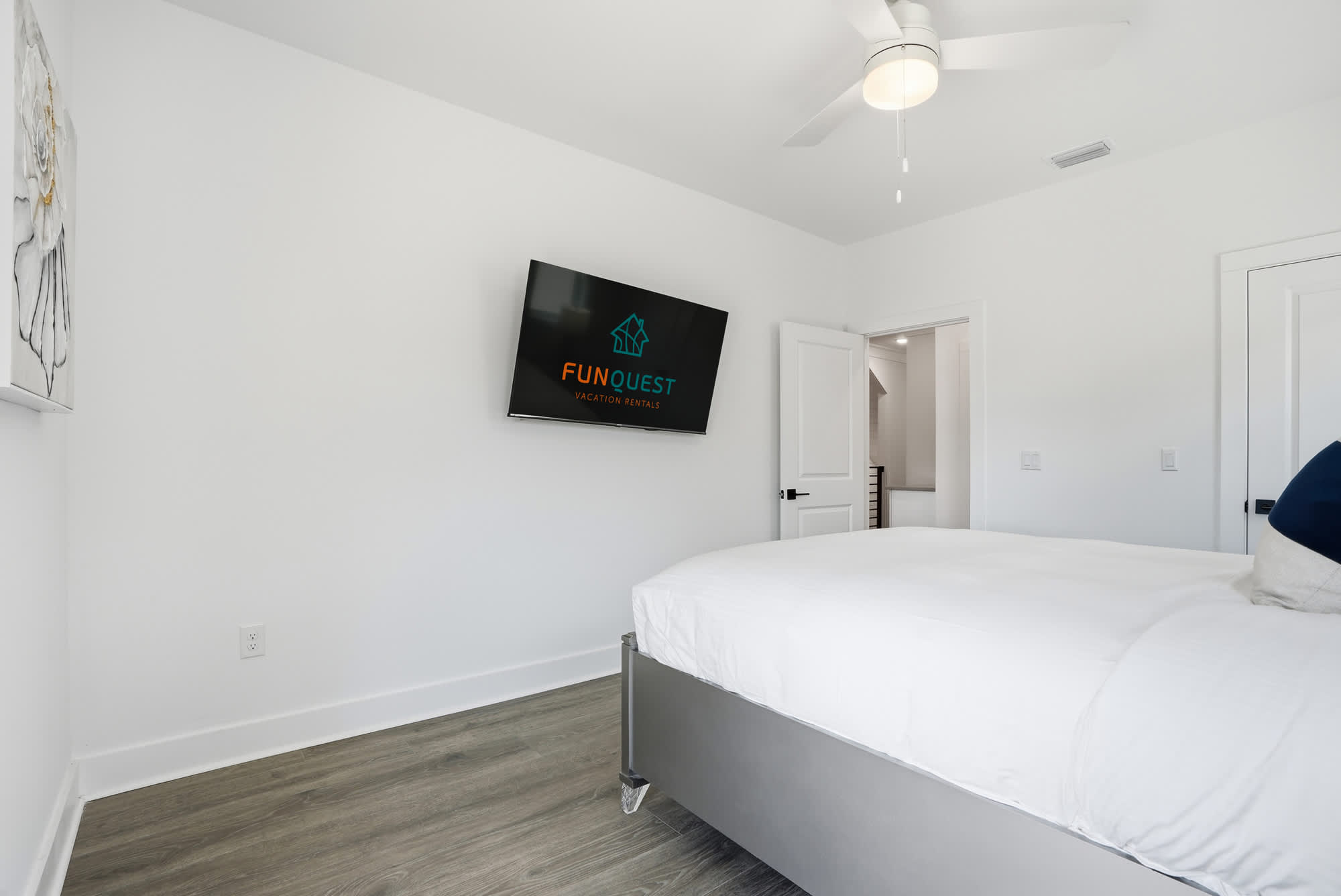 120 Dune Drive – Bedroom with a queen bed, ceiling fan, TV, and white walls.
