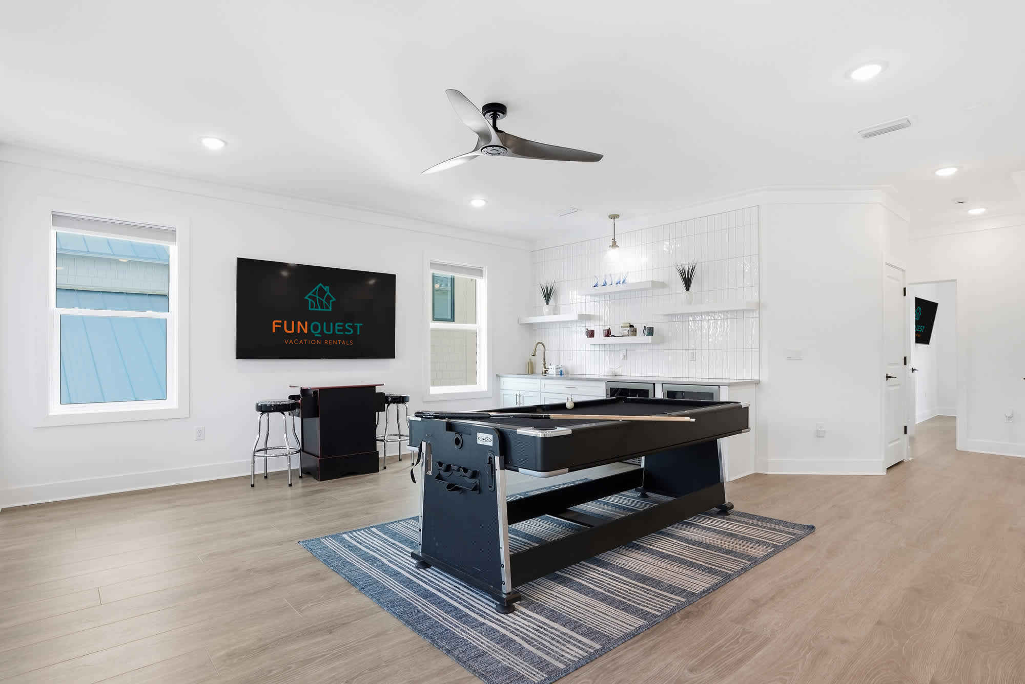 120 Dune Drive – Game room with a pool table, television, and bar seating in a bright, open space.