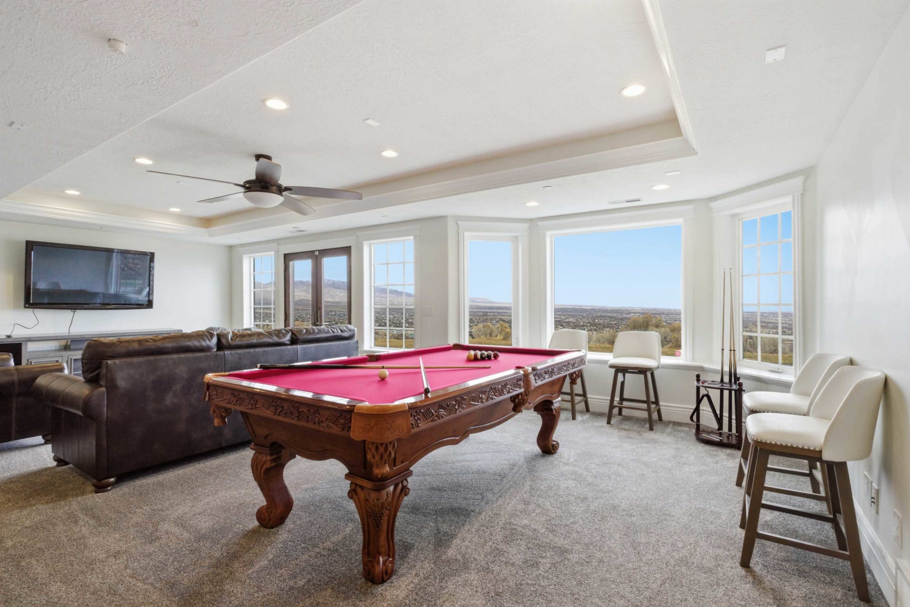 Expansive upper-level living room with wall-to-wall windows