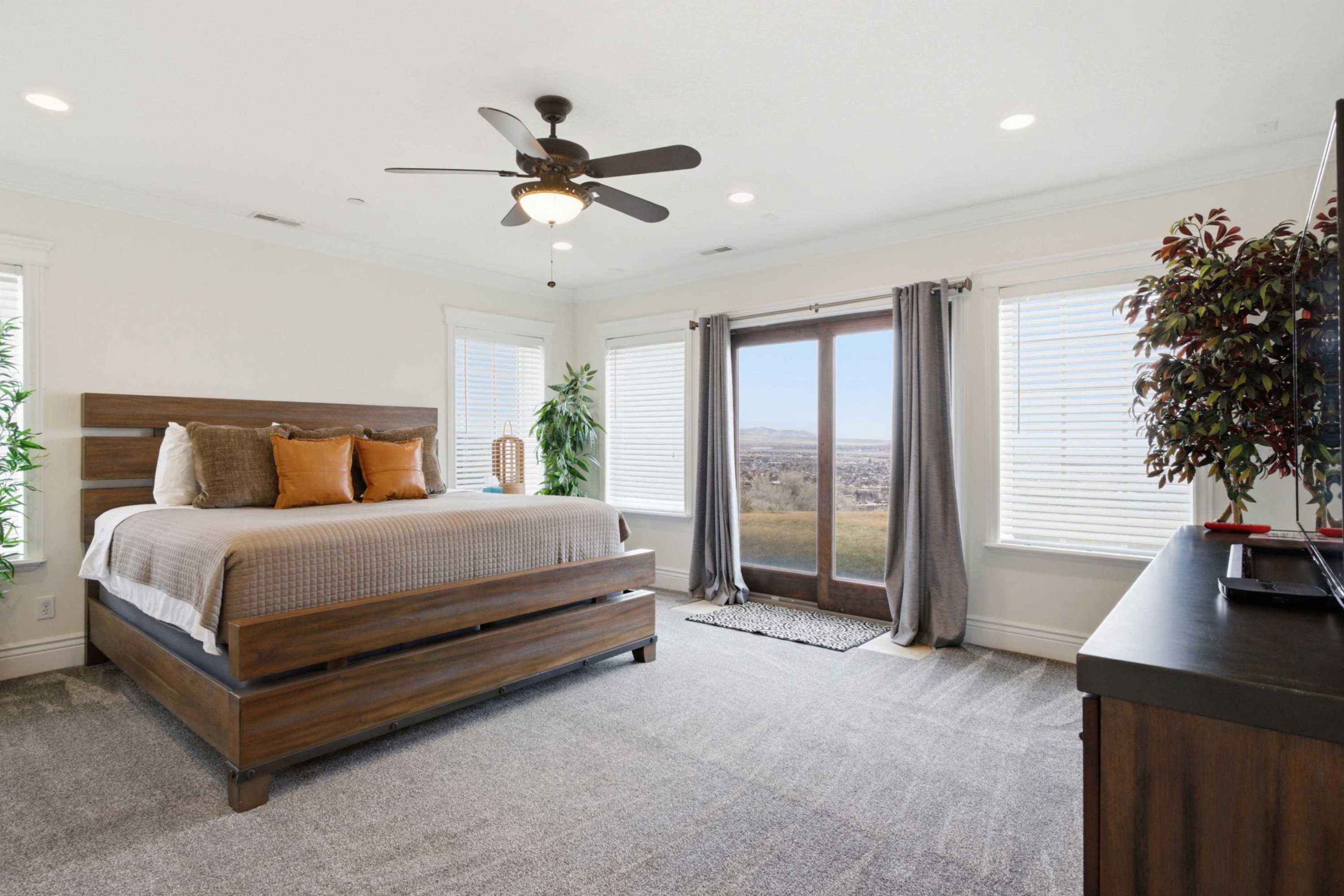 Spacious bedroom with comfortable furnishings and TV