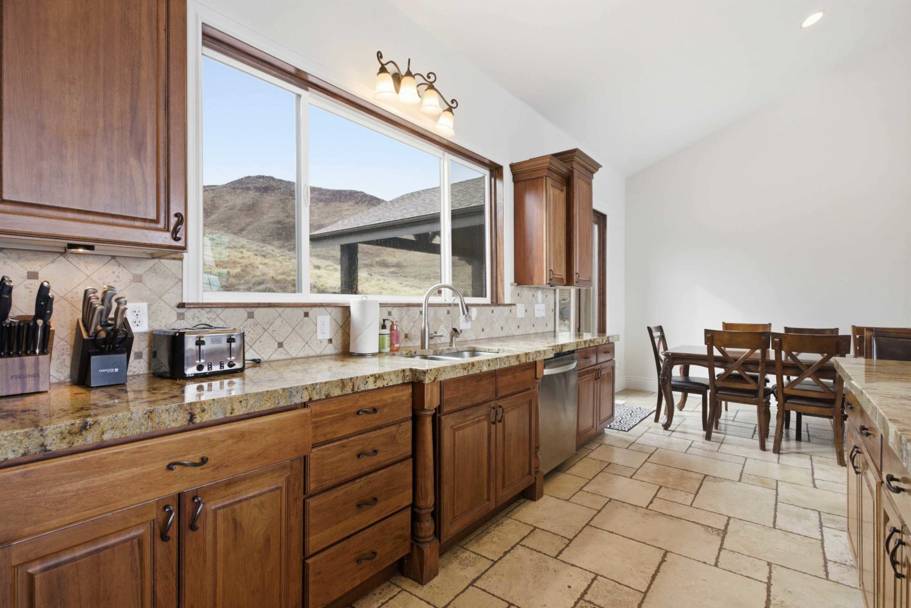 Oversized granite countertops with mountain views and abundant prep space