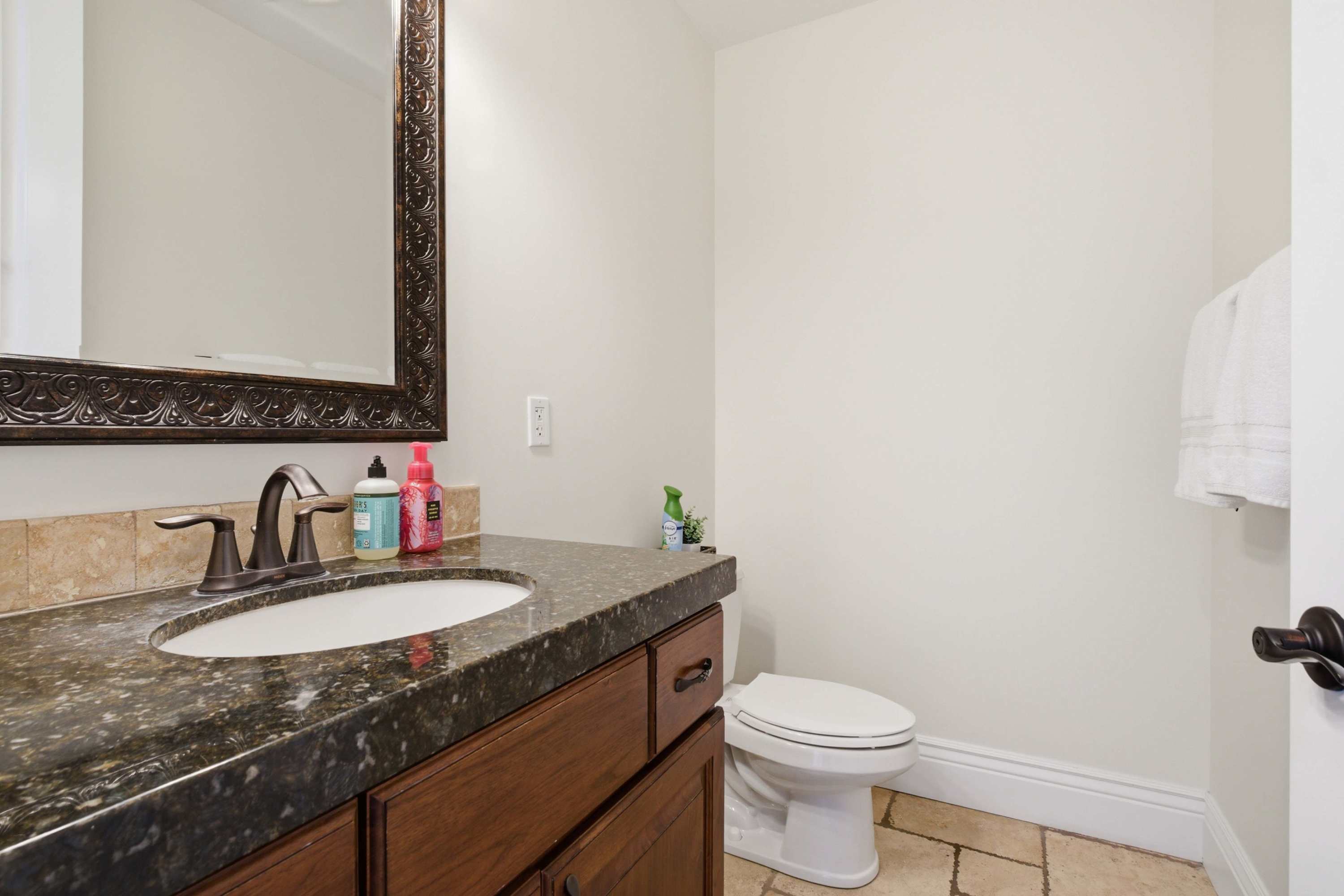 Convenient guest bathroom with granite vanity