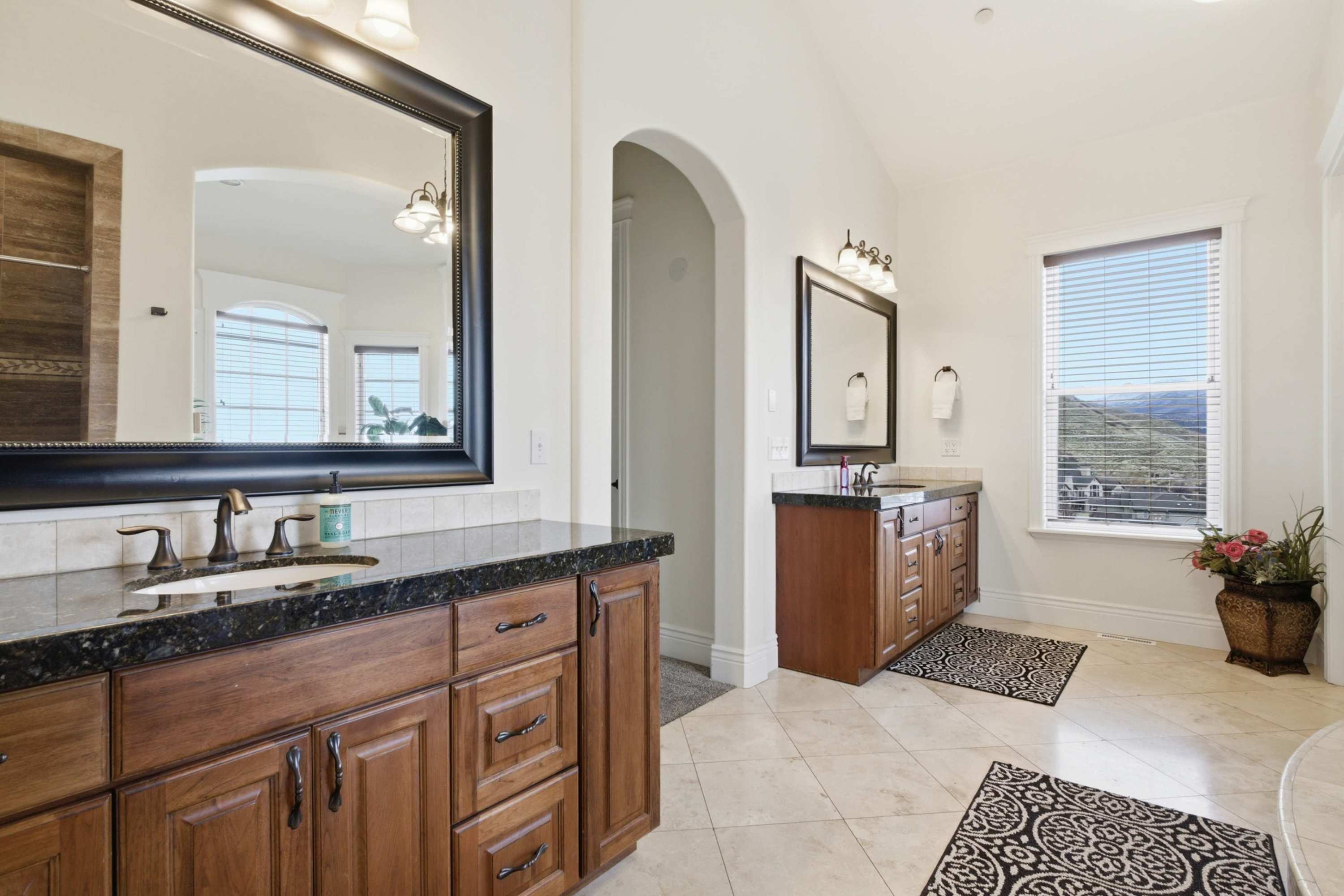 Bright secondary bathroom with large mirror and plenty of counter space