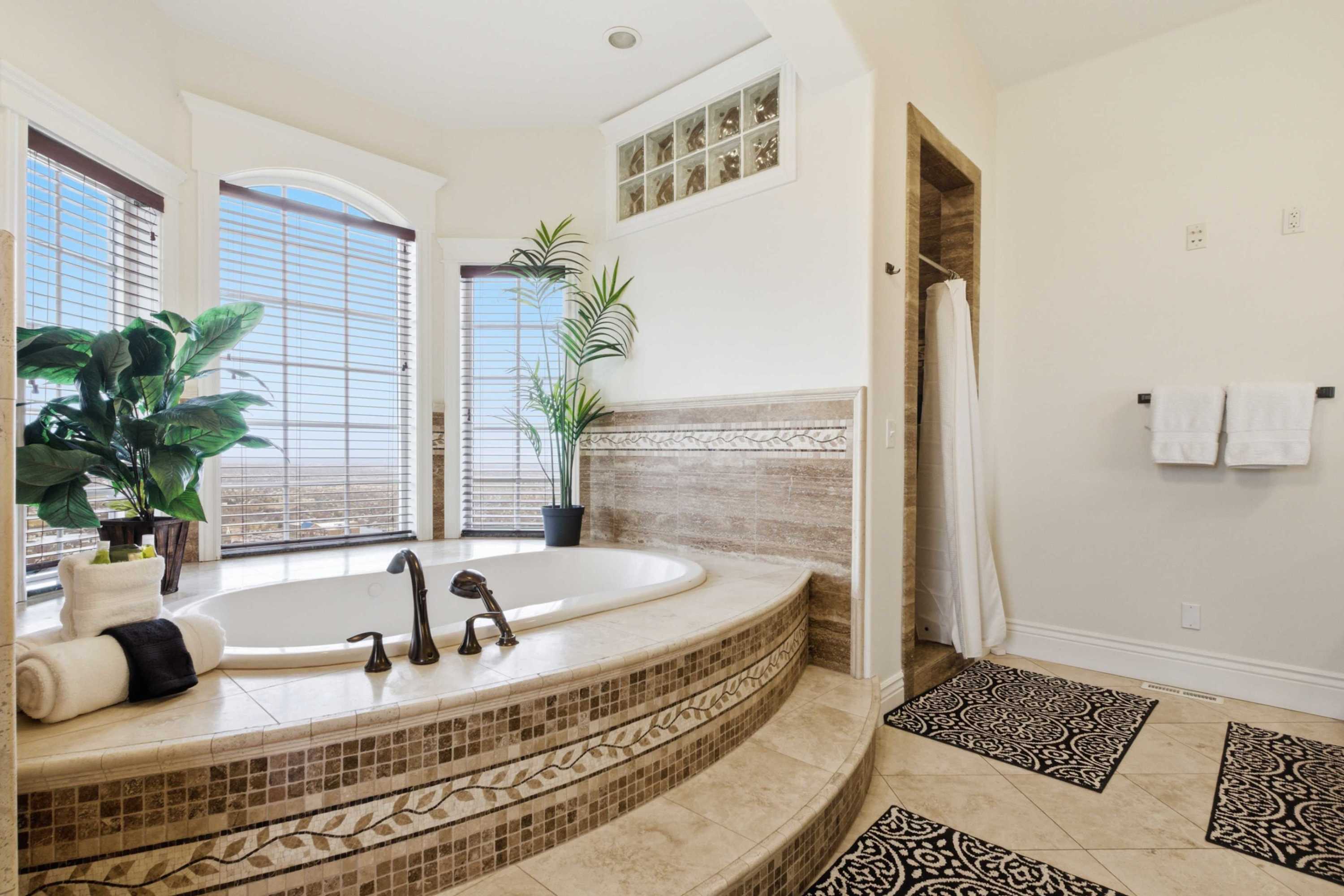 Spacious bathroom layout with tub, shower, and separate vanity area