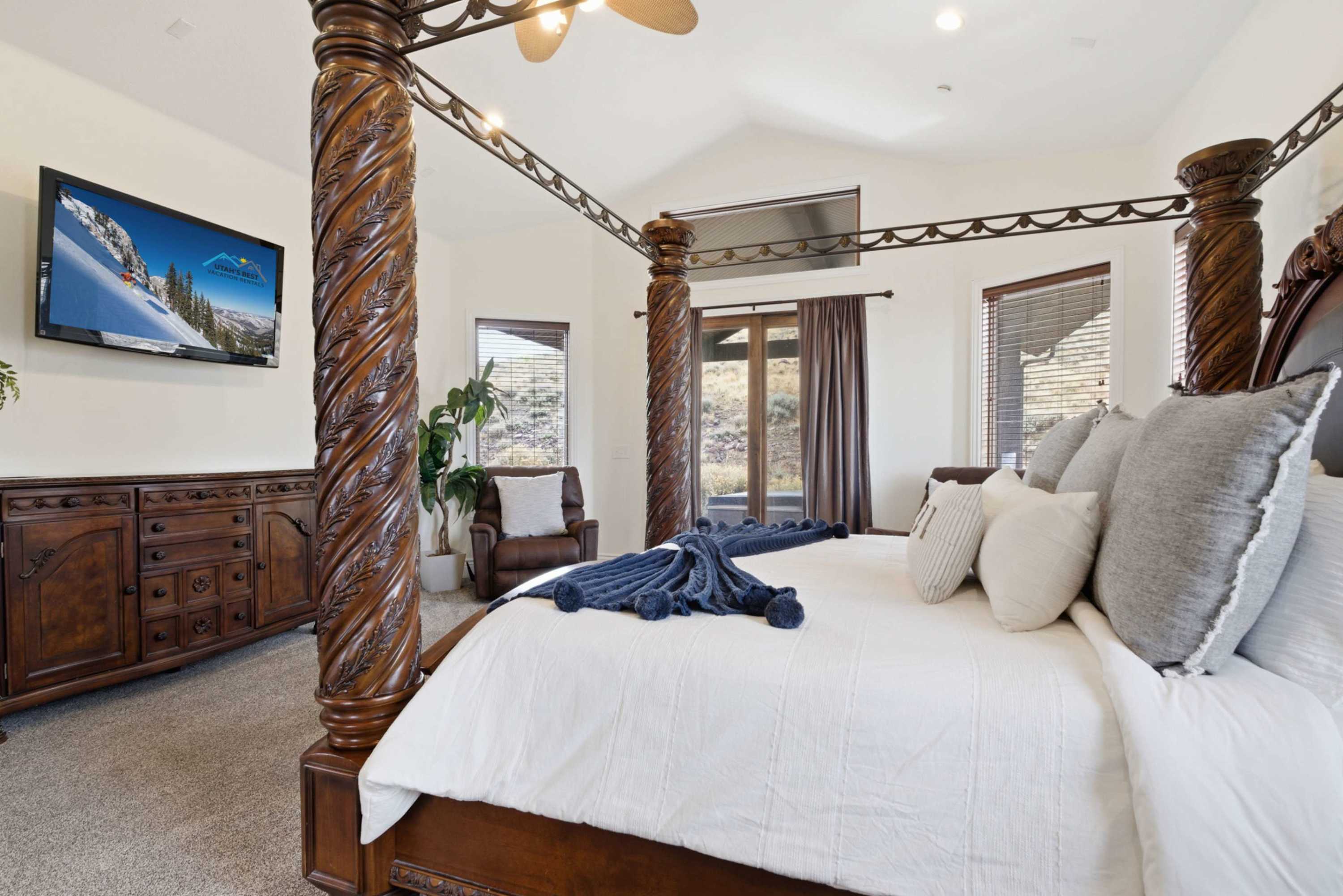 Thoughtfully designed bedroom with TV and ample natural light