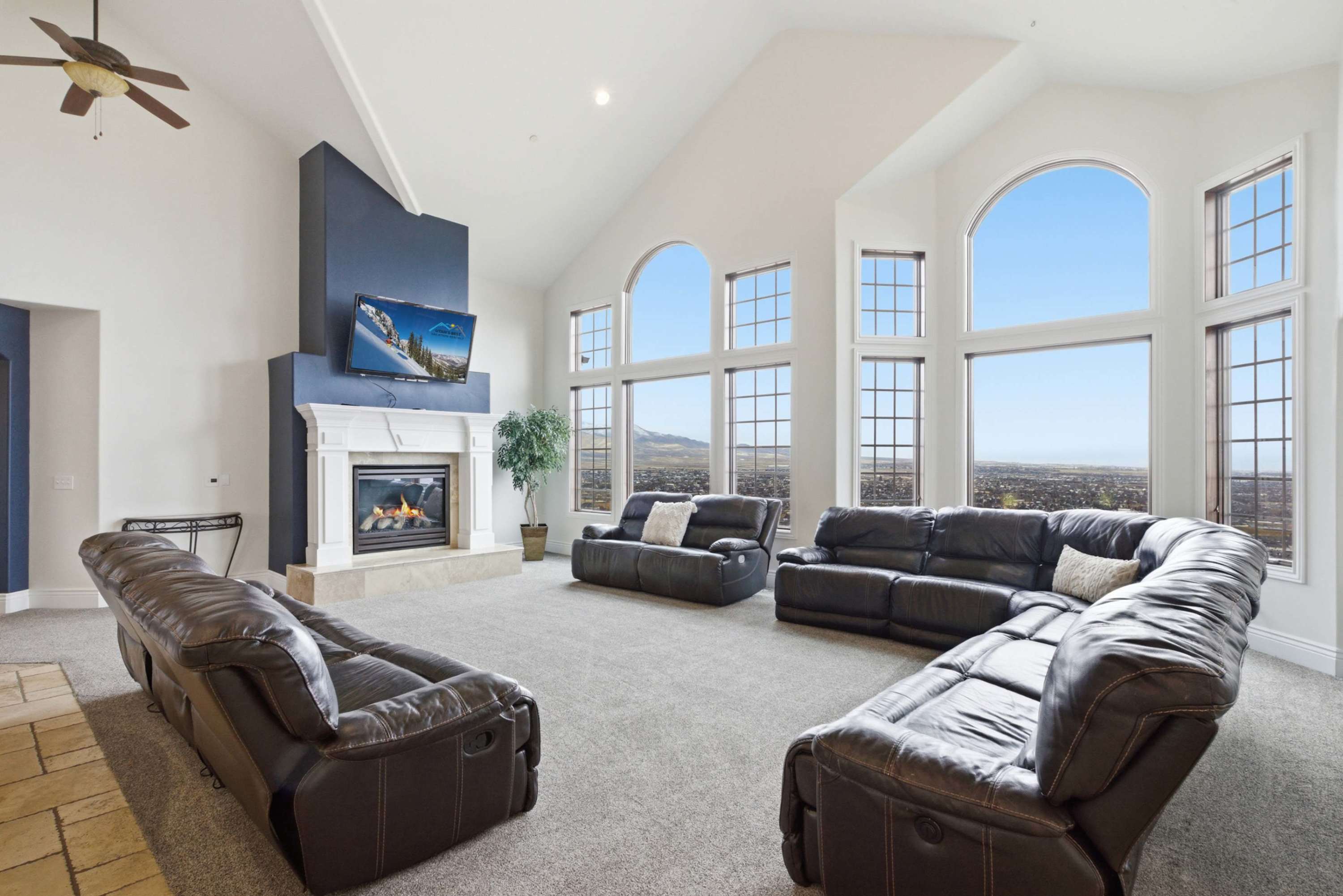 Spacious great room with panoramic windows and elegant fireplace feature wall